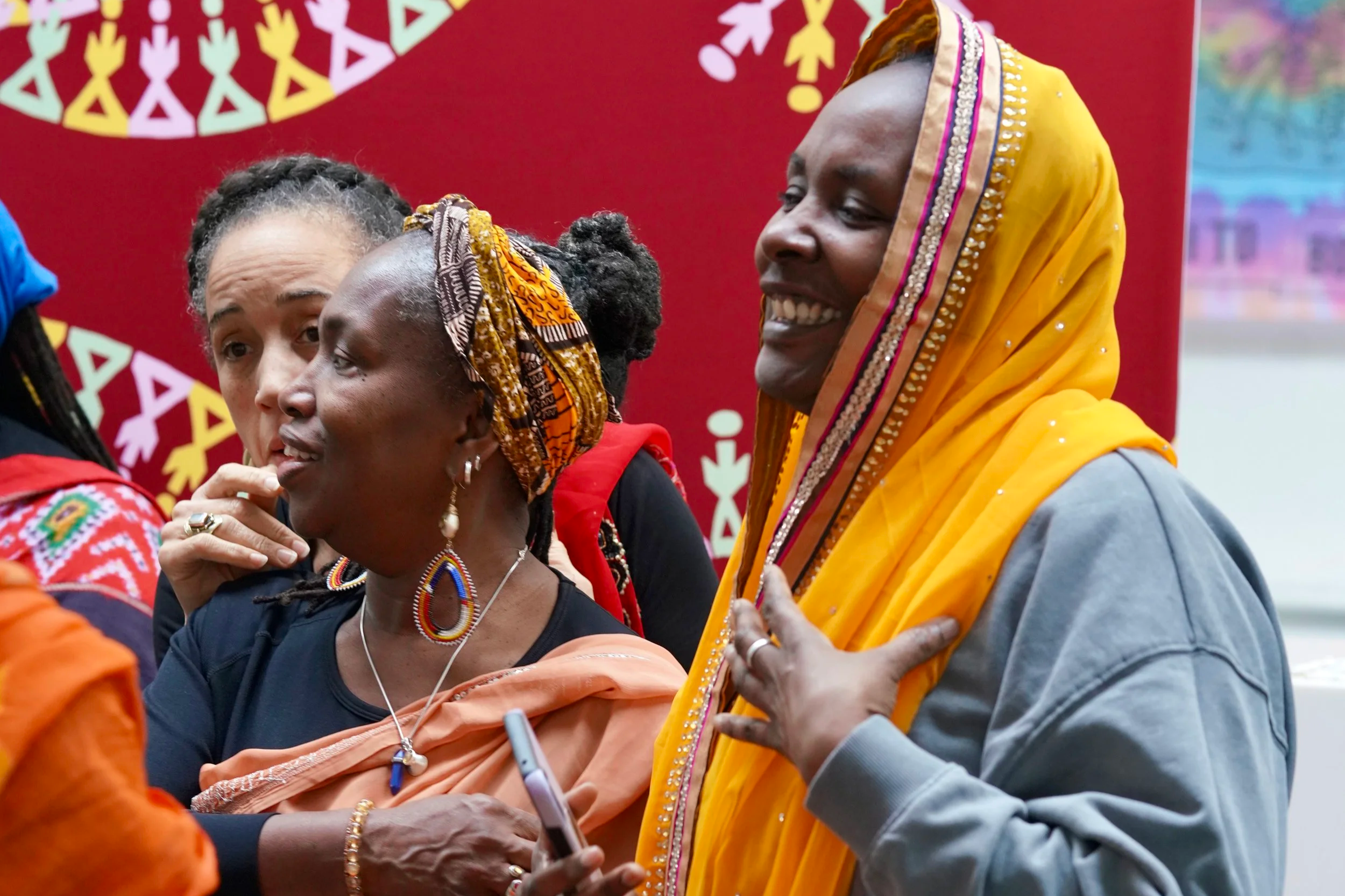 two black british women smiling away from the camera
