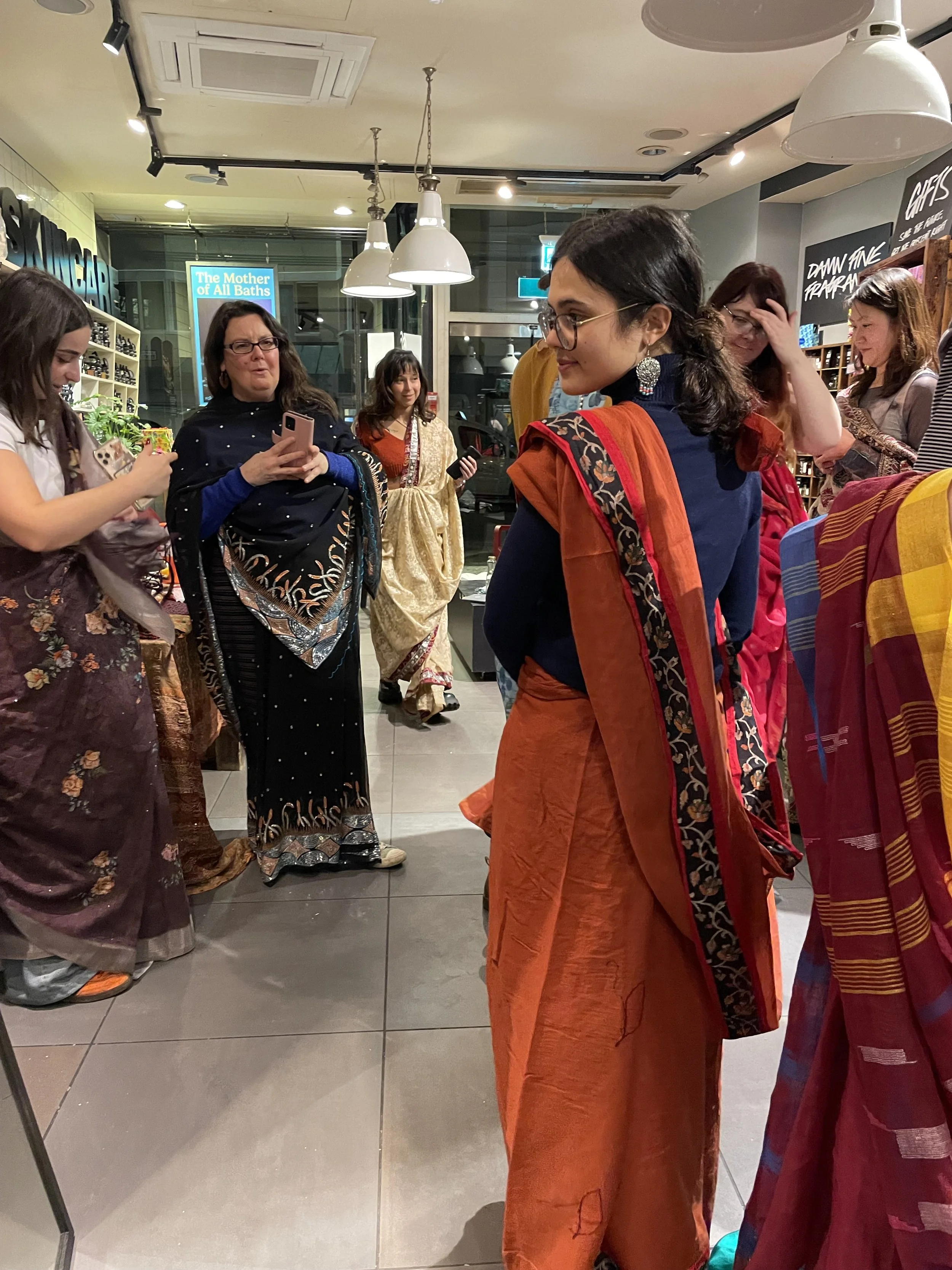 A group of women wearing colourful sarees
