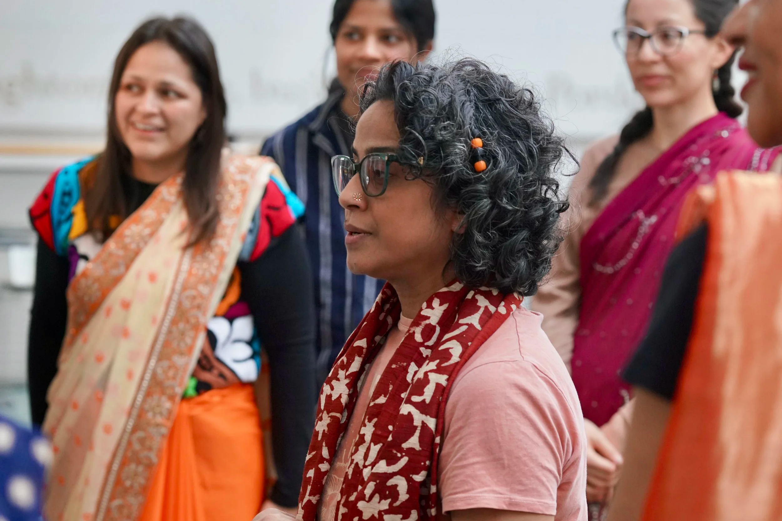 Poppy, a British-Bangladeshi woman speaking. Side profile shot