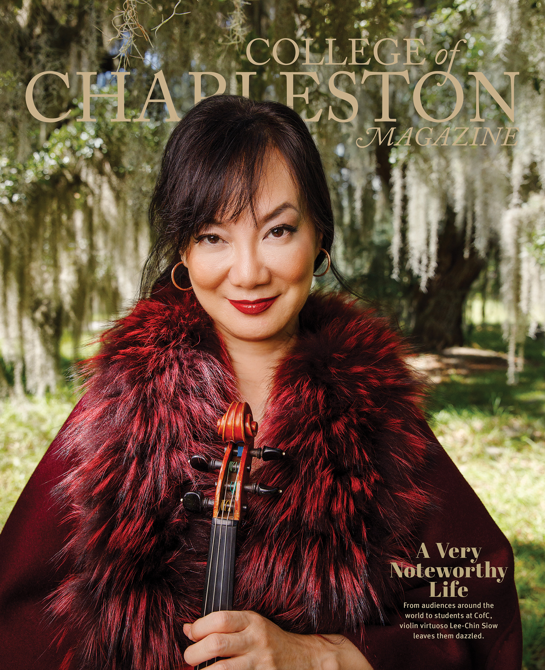 Magazine cover featuring a woman in a red fur coat holding a violin outdoors with trees and Spanish moss in the background. The text reads 'College of Charleston Magazine' and 'A Very Noteworthy Life'.