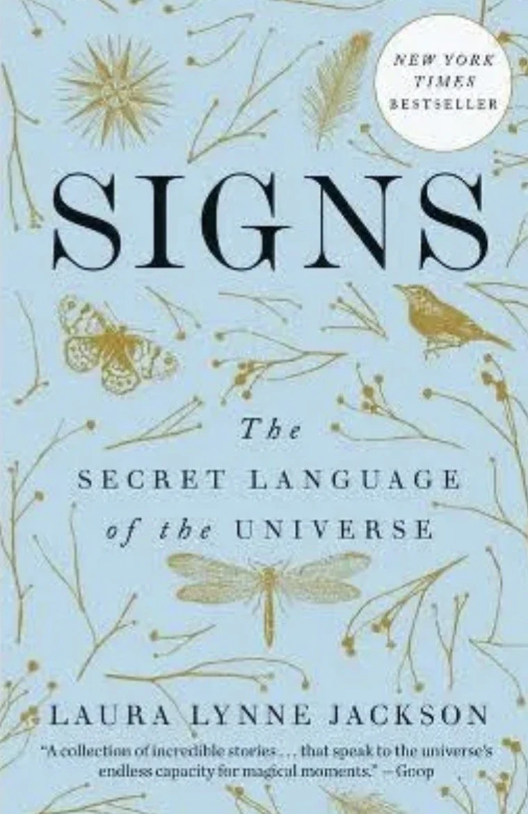 Book cover titled 'Signs: The Secret Language of the Universe' by Laura Lynne Jackson, with a pale blue background decorated with botanical sketches and insects.