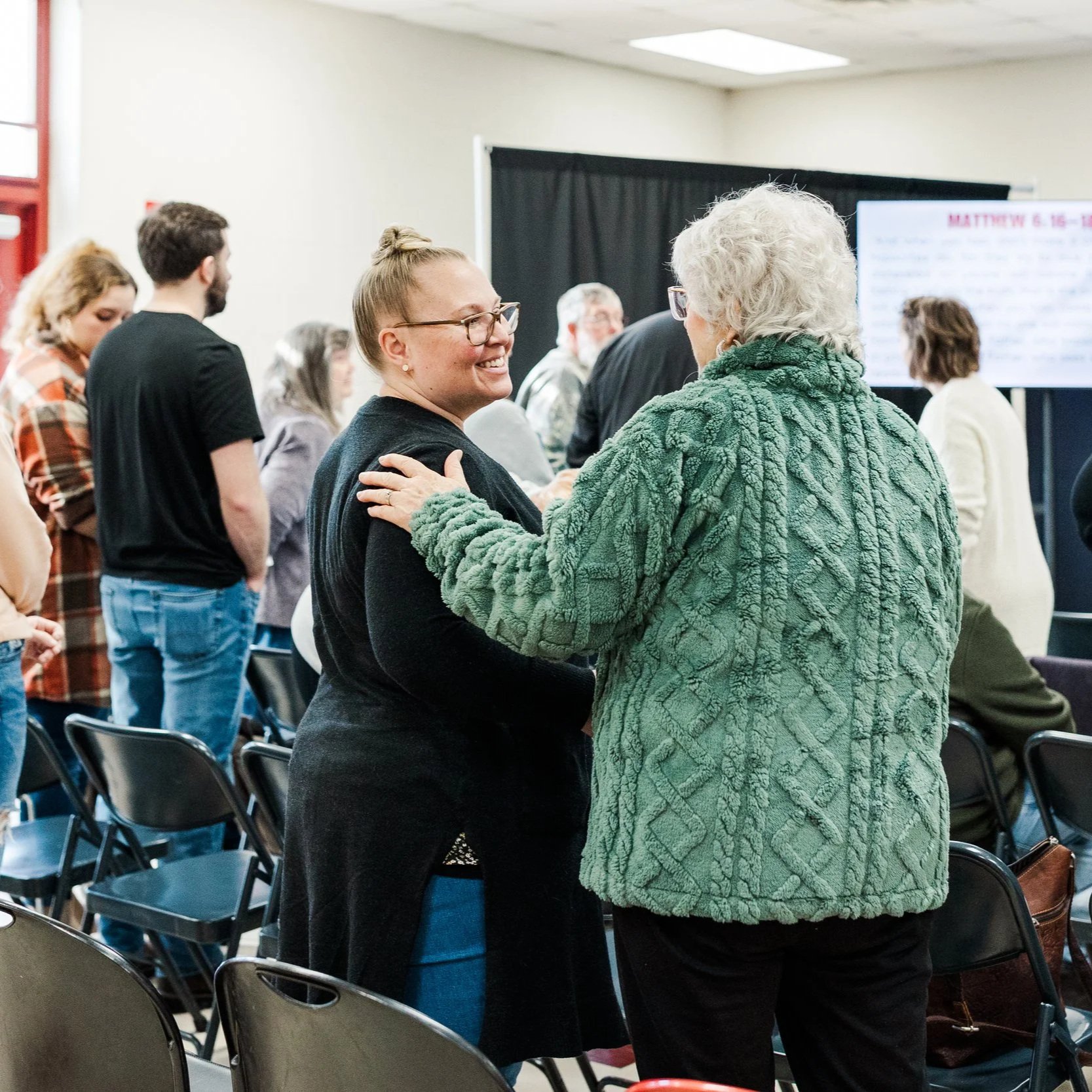 Two women greeting at church service in New Castle, Indiana at the Henry County YMCA