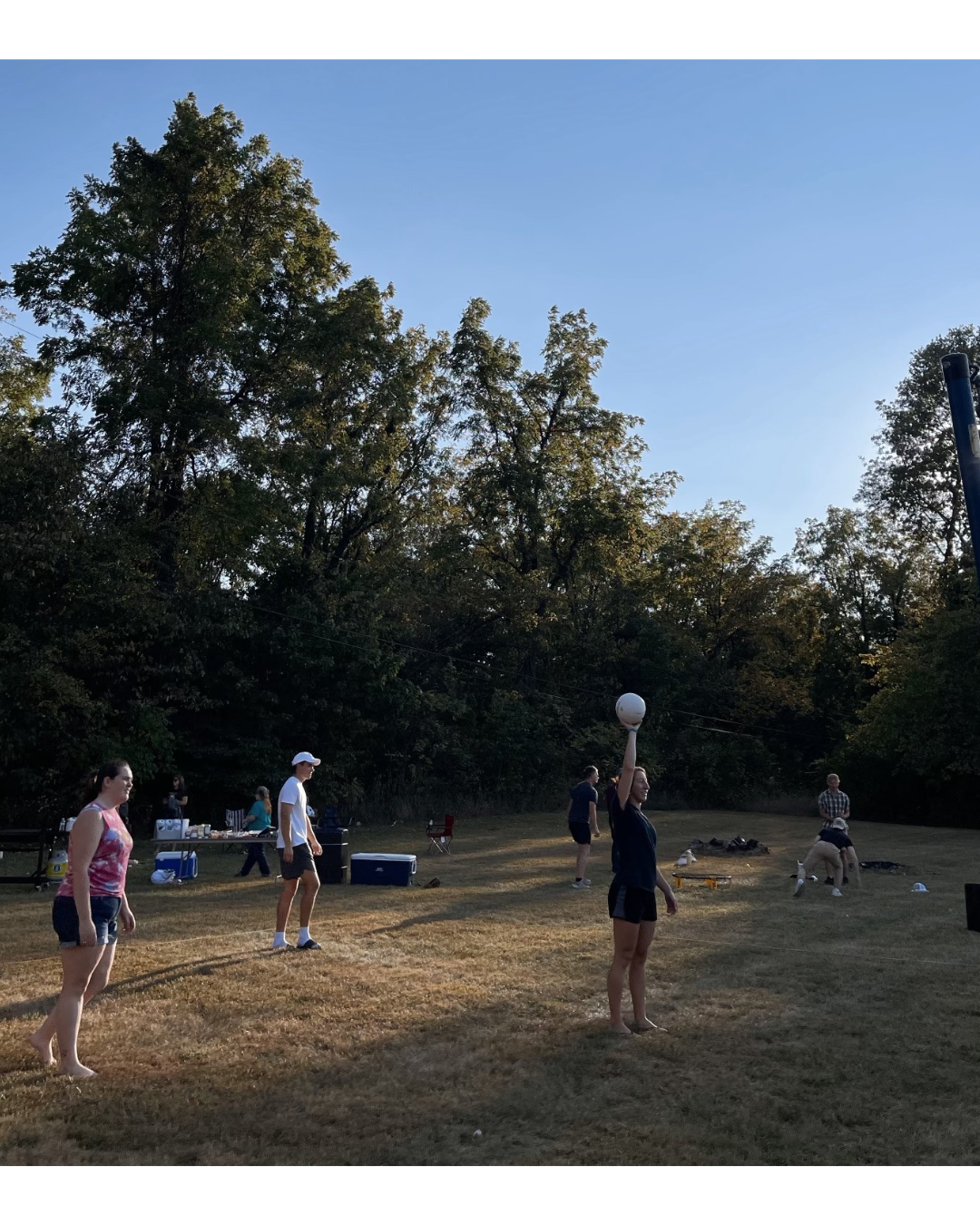 Young adults outside enjoying playing games together and cooking out at Glad Tidings Church Young Adults ministry.