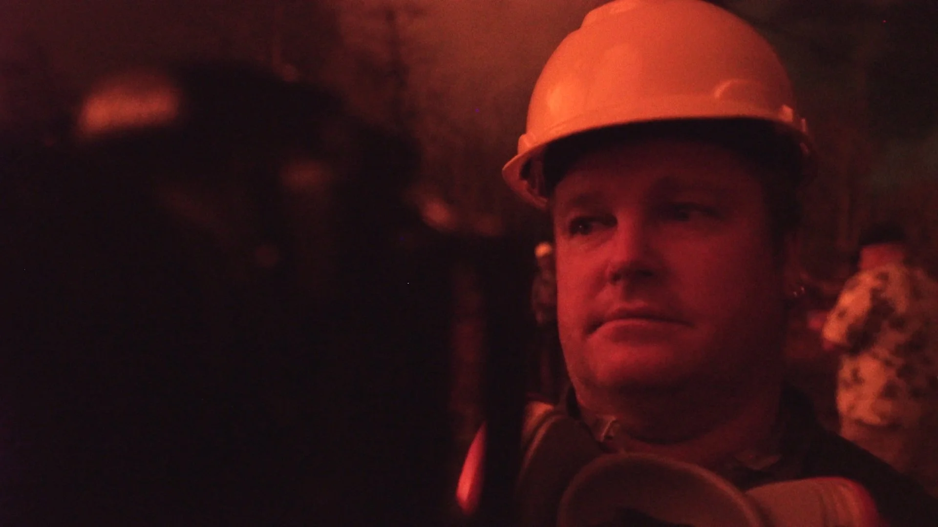 Volcano photographer CJ Kale at work in the field on the Big Island of Hawaii, his face illuminated by the glow of active lava during the filming of Volcano Gems for Galileo/ProSieben.