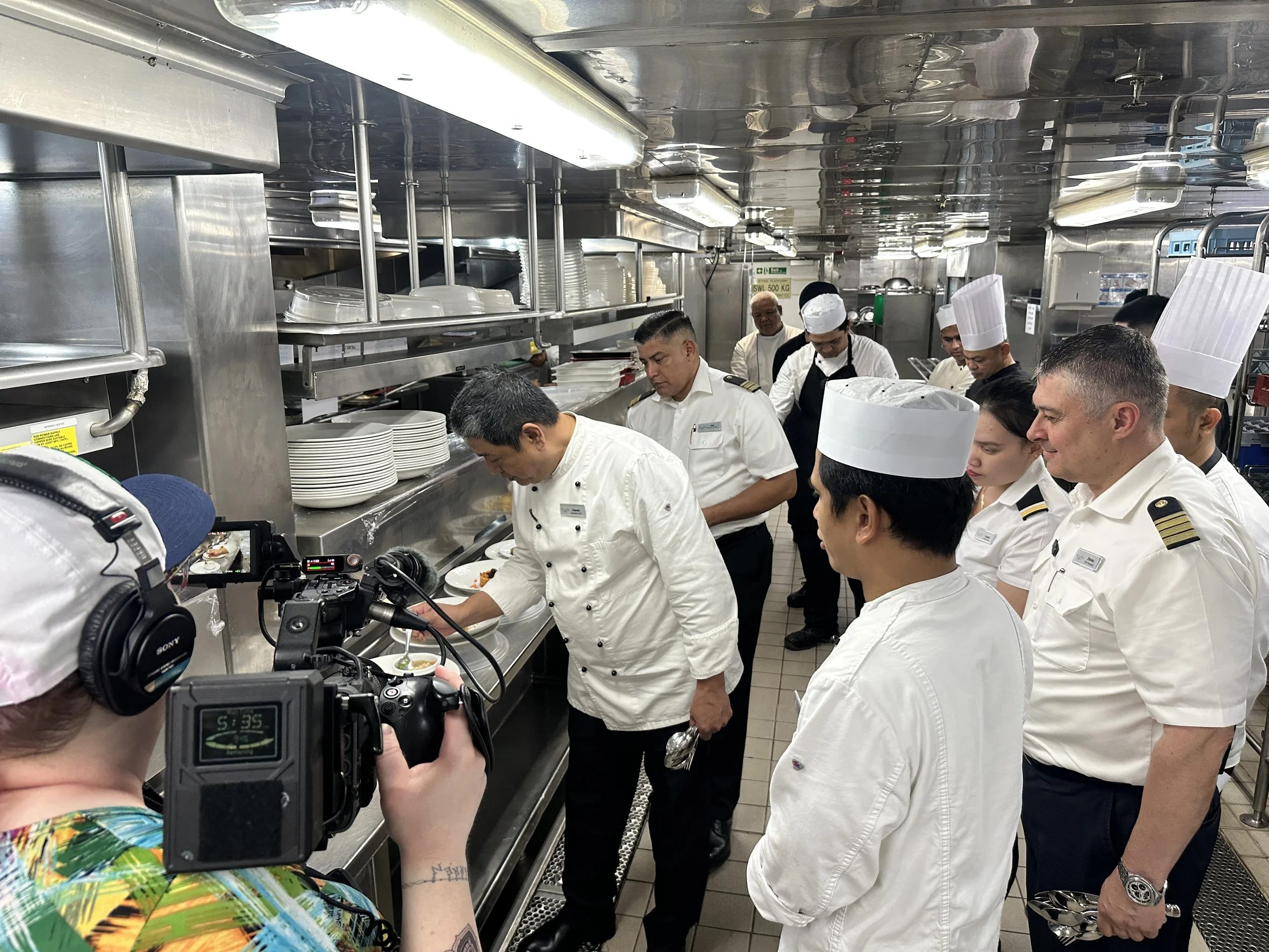 DP Chandler Knowles films the Odyssey kitchen crew during a food presentation on board