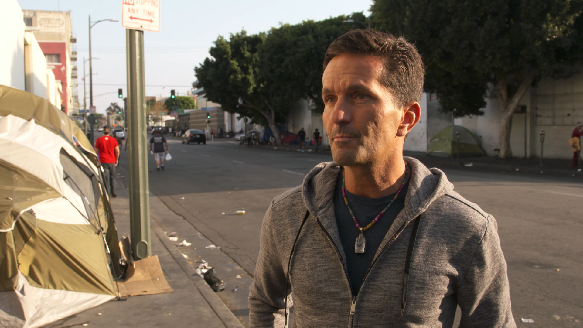 Khalil Rafati, founder of Sunlife Organics, stands on Skid Row in Los Angeles during filming for a documentary about his journey from homelessness to building a multi-million dollar wellness company.