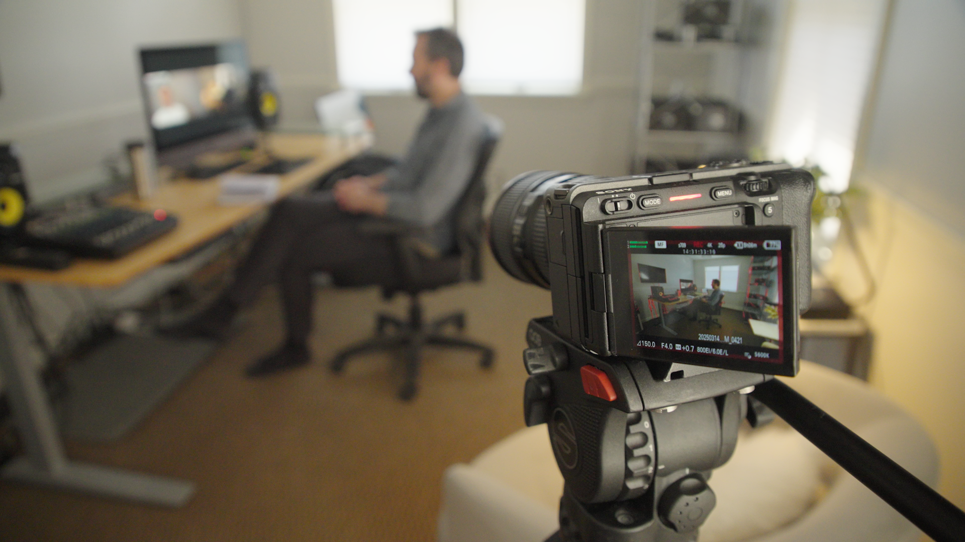 Camera capturing our producer engaged in a Zoom call, highlighting behind-the-scenes production setup for the American Dream shoot.