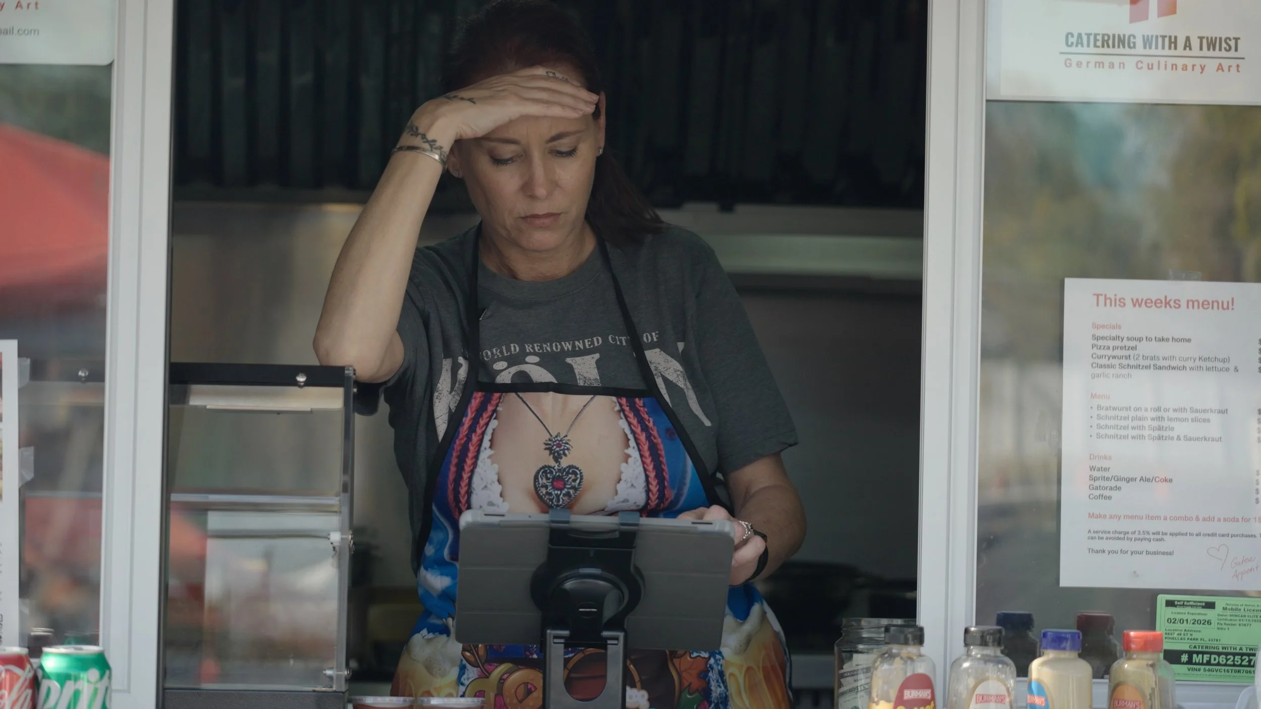 Film still from documentary featuring Christiane at work inside her German food truck, Catering with a Twist