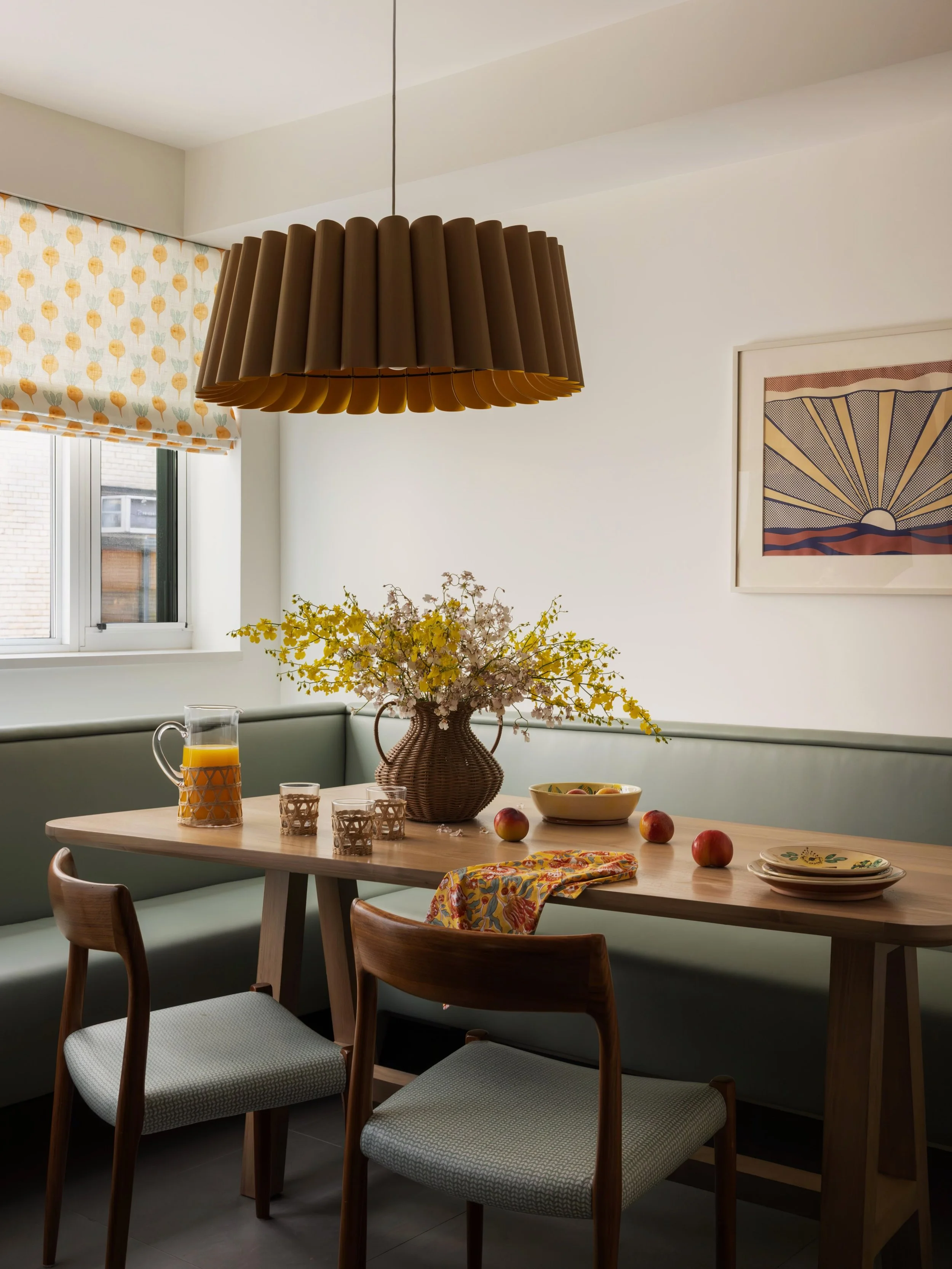 A kitchen nook built around a love of little radishes&nbsp;🌱
The roman shade fabric stole our hearts first and everything else followed. A geometric table, performance leather banquette (hello, wipeable + kid-friendly!), and a light fixture passed d