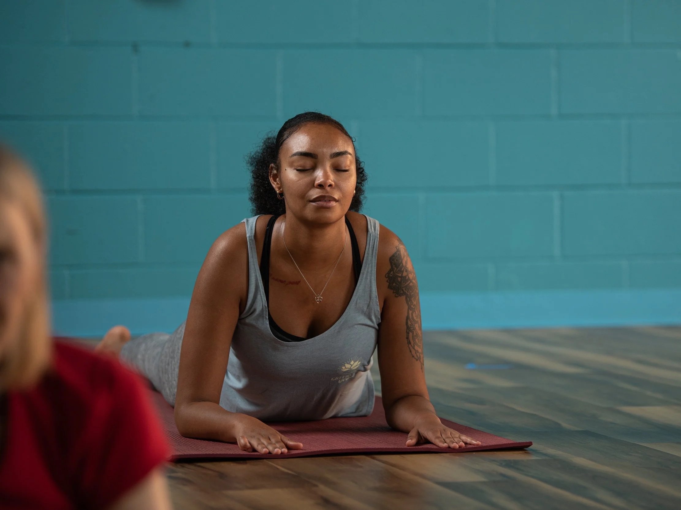 student in sphinx pose looking peaceful