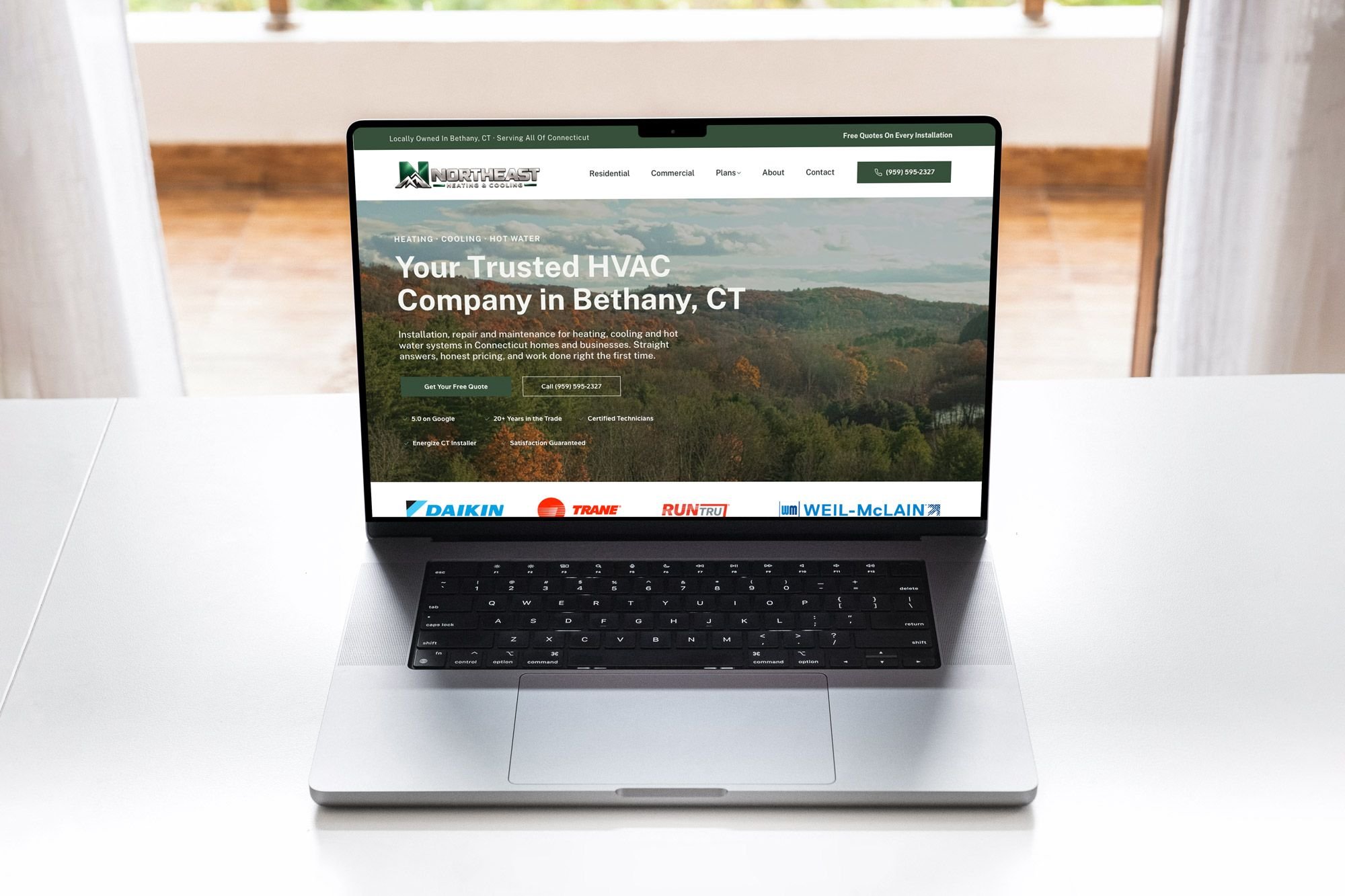 The refreshed NorthEast Heating & Cooling homepage shown on a MacBook, with a clear hero message and free quote call to action