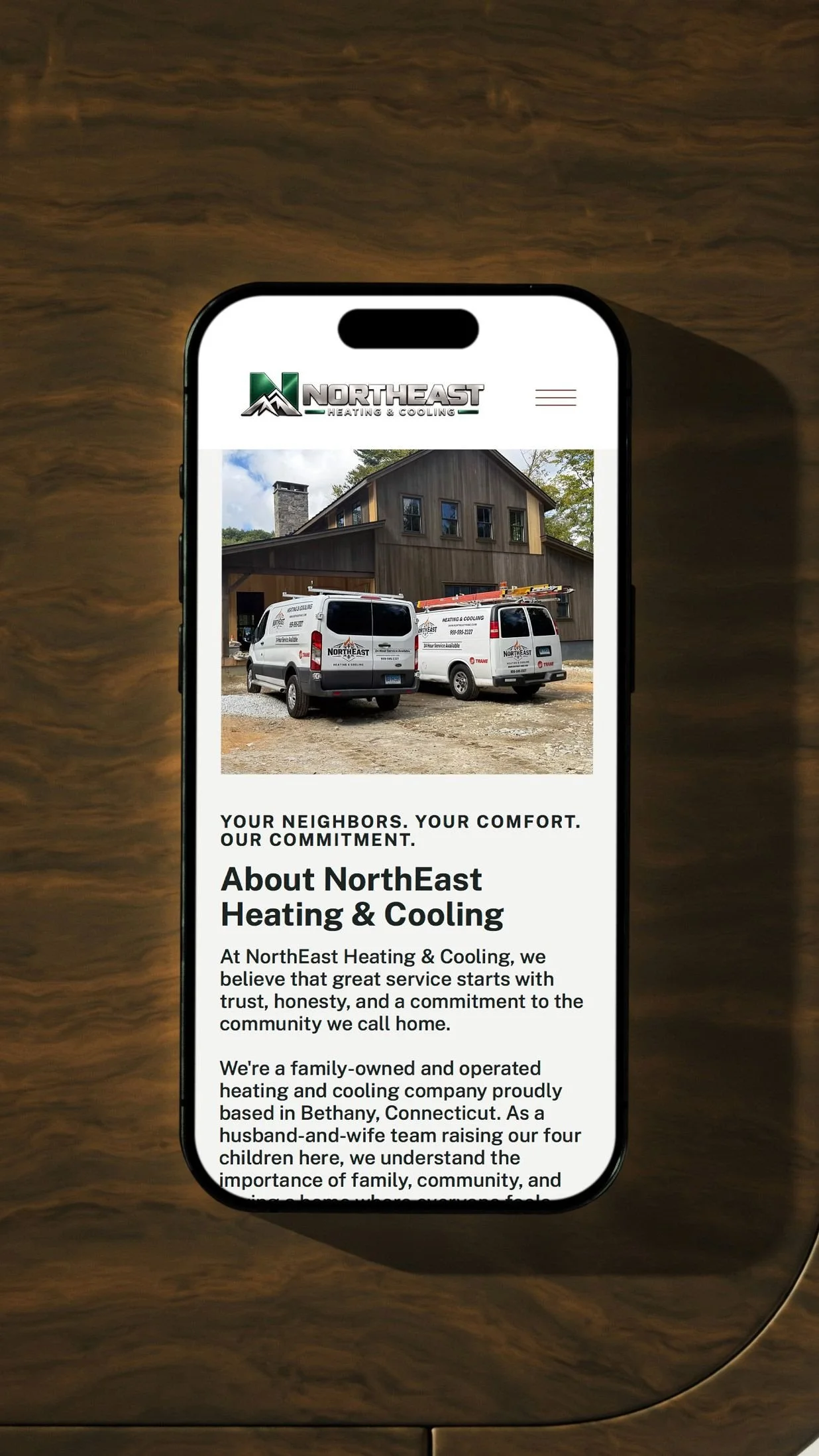 The NorthEast Heating & Cooling about section shown on an iPhone, with the company's branded vans and hometown story