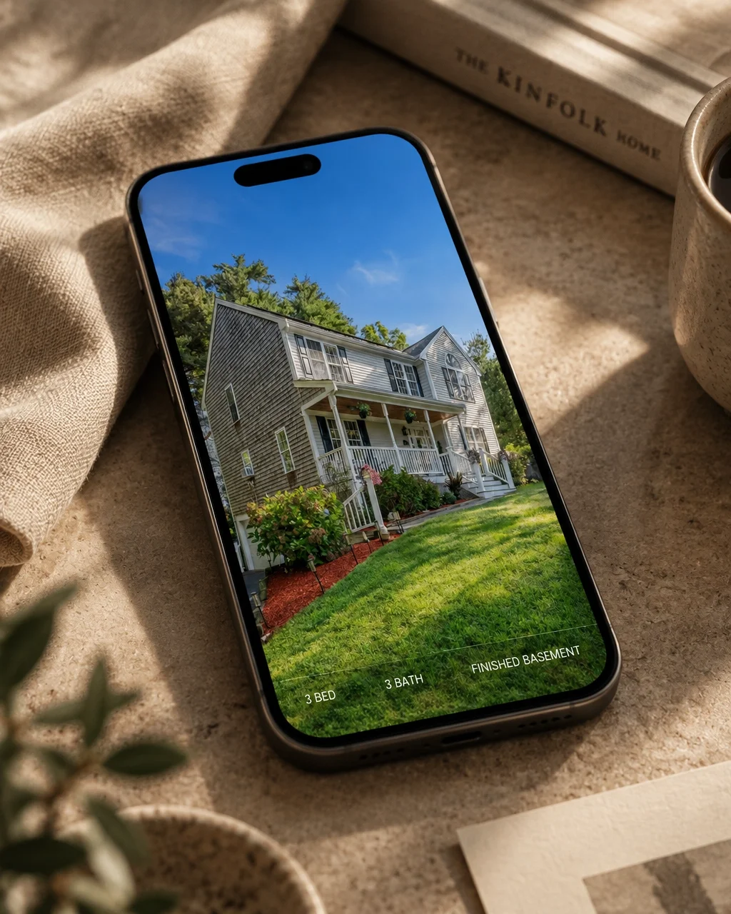 A property feature Instagram template created for a real estate client, shown on a phone in a warm editorial setting
