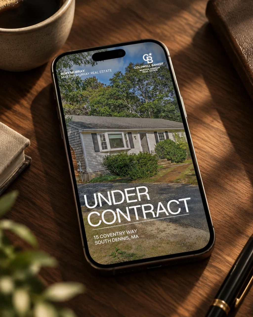 An under contract Instagram story template created for a real estate client, shown on a phone in a warm editorial setting