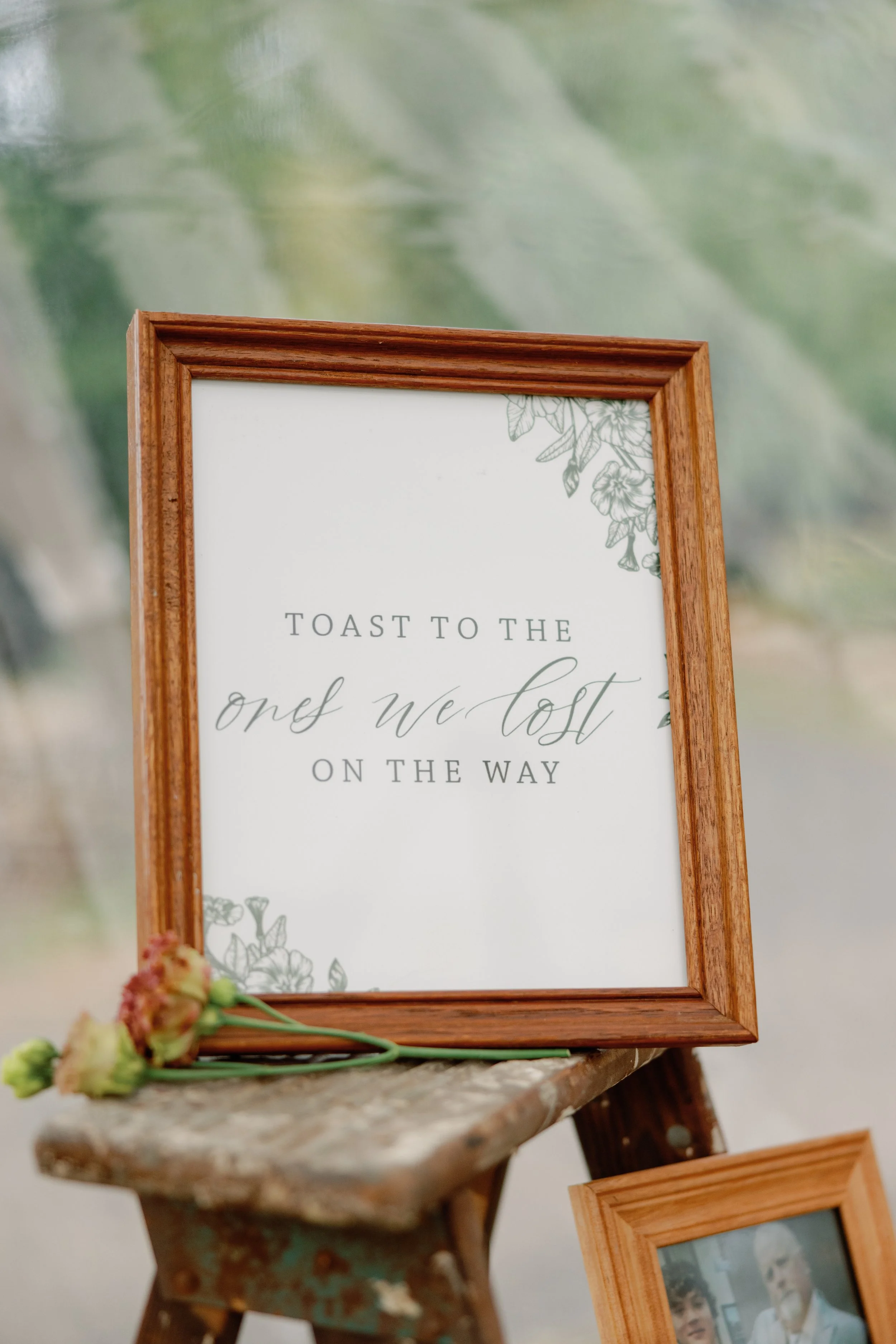 Ivory wedding sign reading A Toast for the Ones We Lost Along the Way, displayed at an outdoor Connecticut wedding reception.