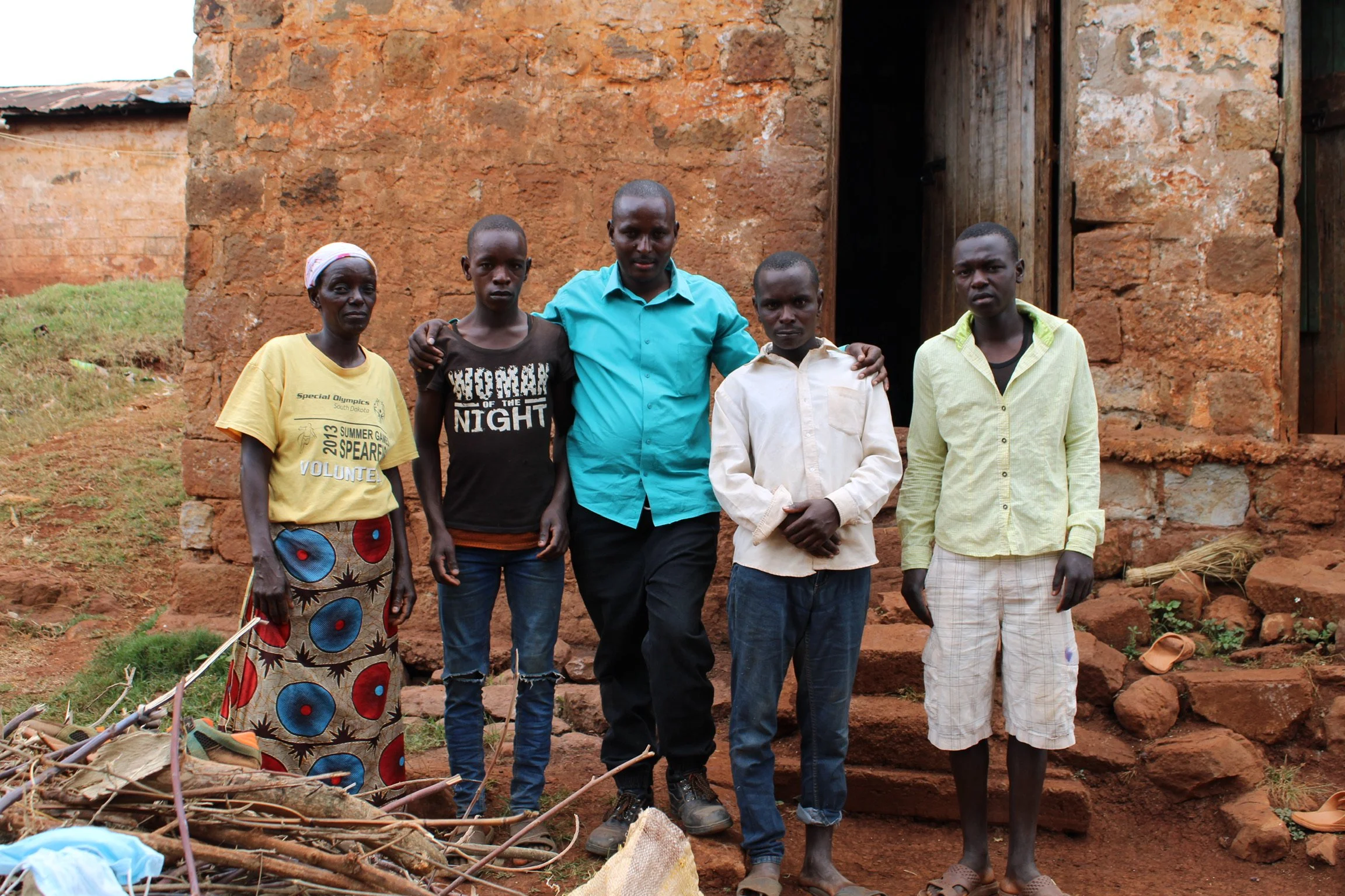 Robert pictured here with a widow and her three sons—two developmentally challenged.  The other son was unable to continue in school after he finished the primary program because he couldn’t afford the registration fee of $20.