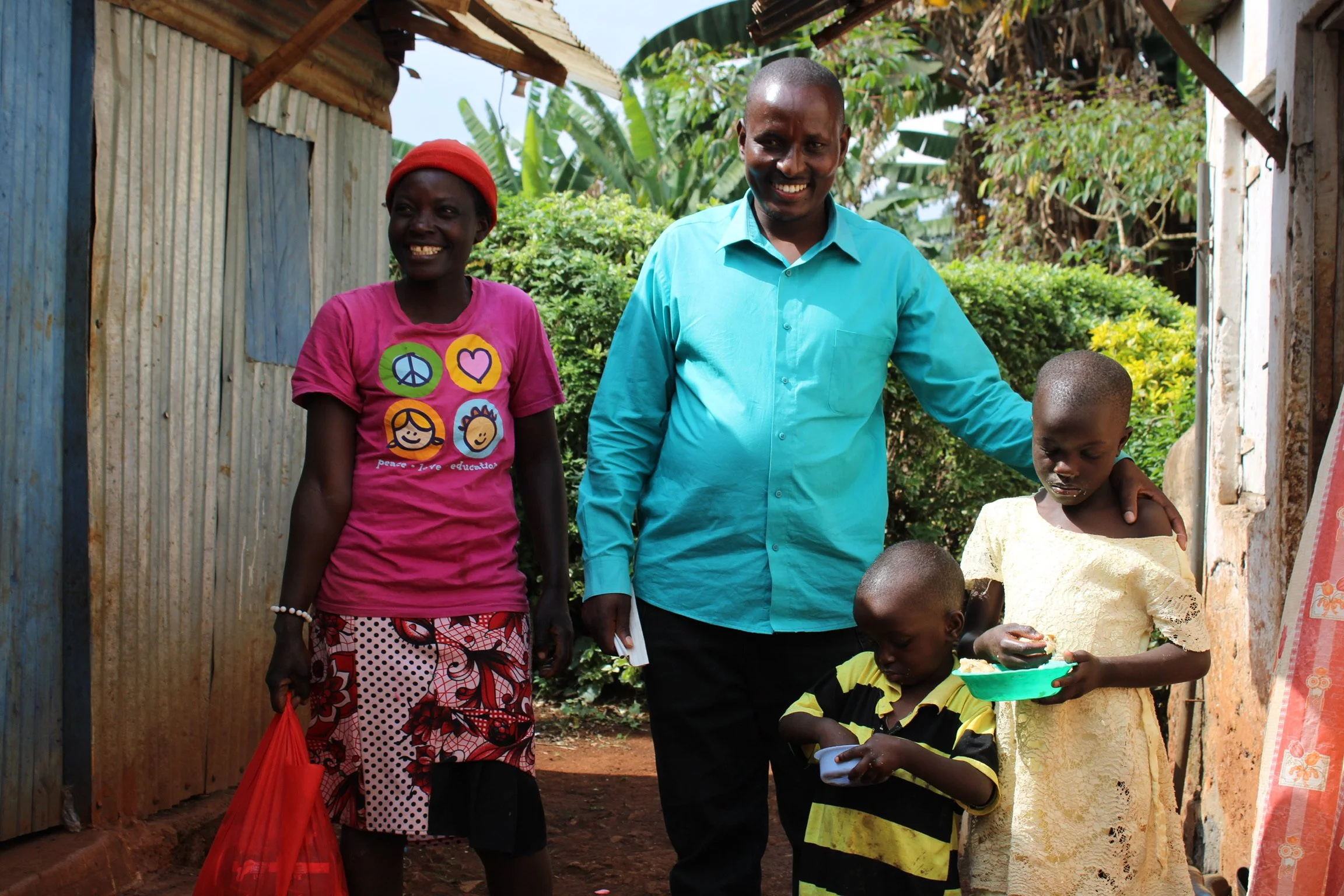 Pastor Robert delivering a food package to a young community family.