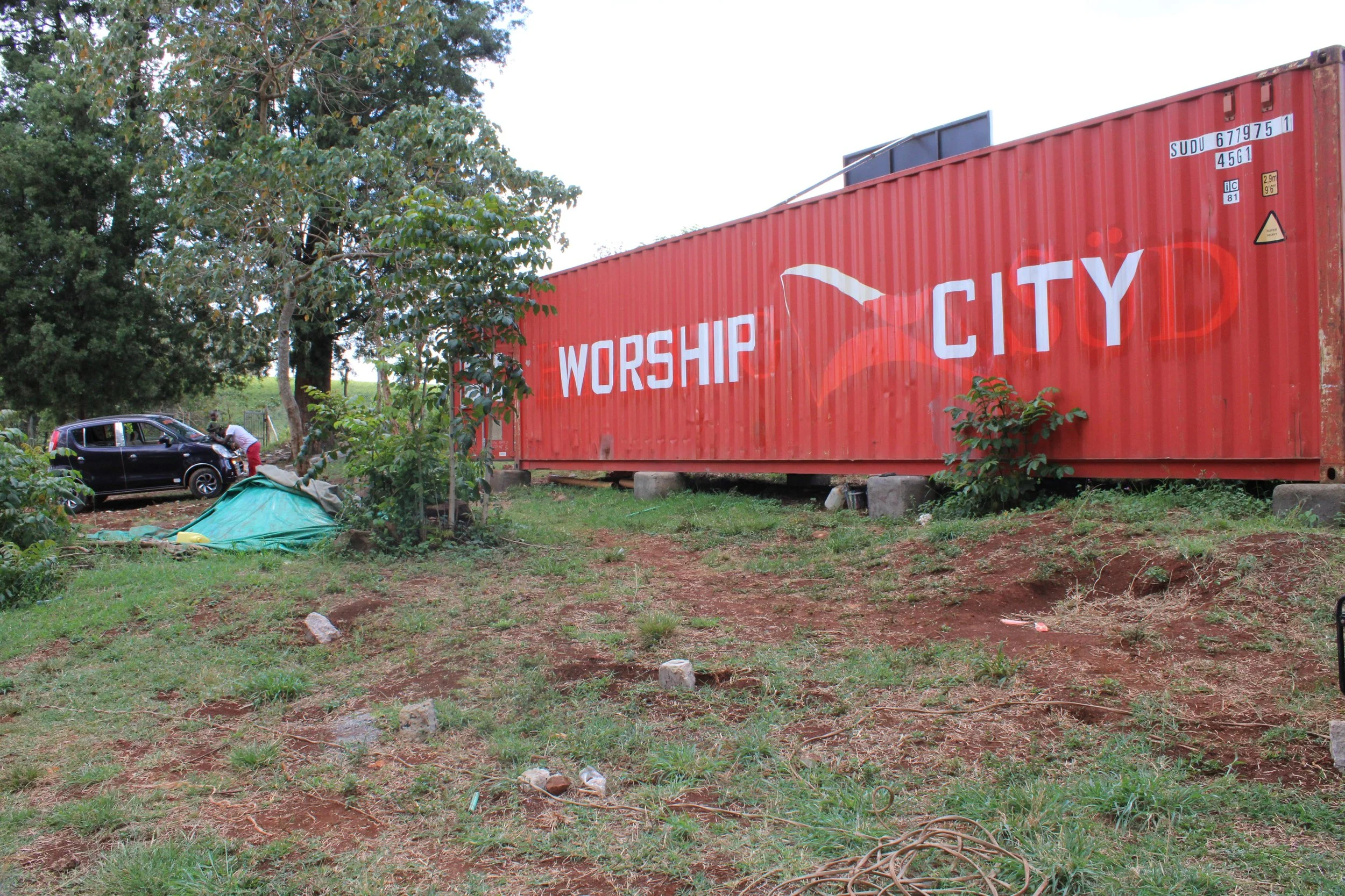 The exterior of the Worship City container on site provides area for church office as well as storage of church equipment.