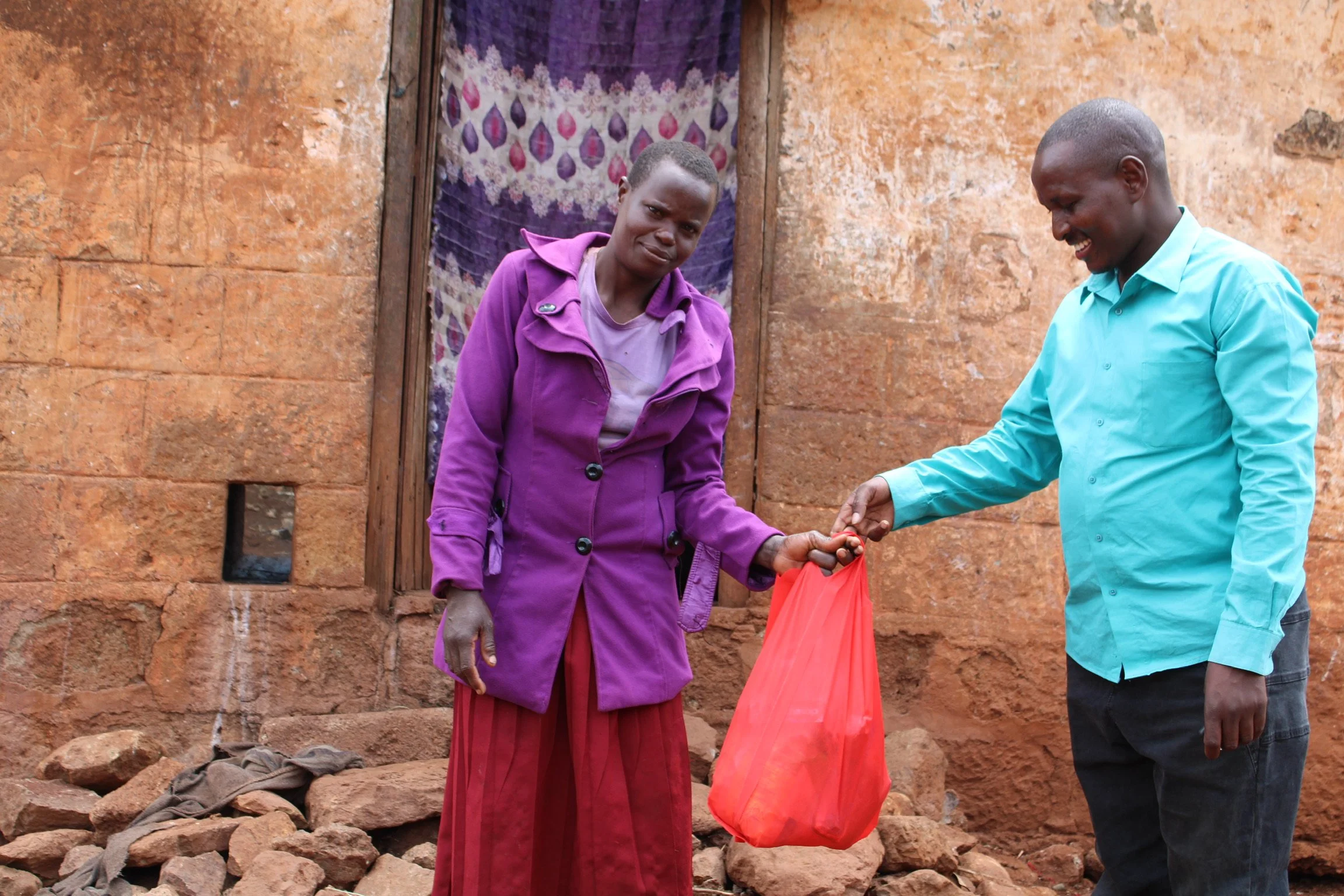 Pastor Robert provides a food package to another grateful recipient. 