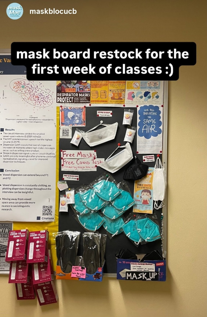 A social media post from Mask Bloc UC Berkeley displaying their mask board and the text "mask board restock for the first week of classes :)" On the board are a variety of masks, flyers, and COVID tests. They also have posted some DIY drink valves fr