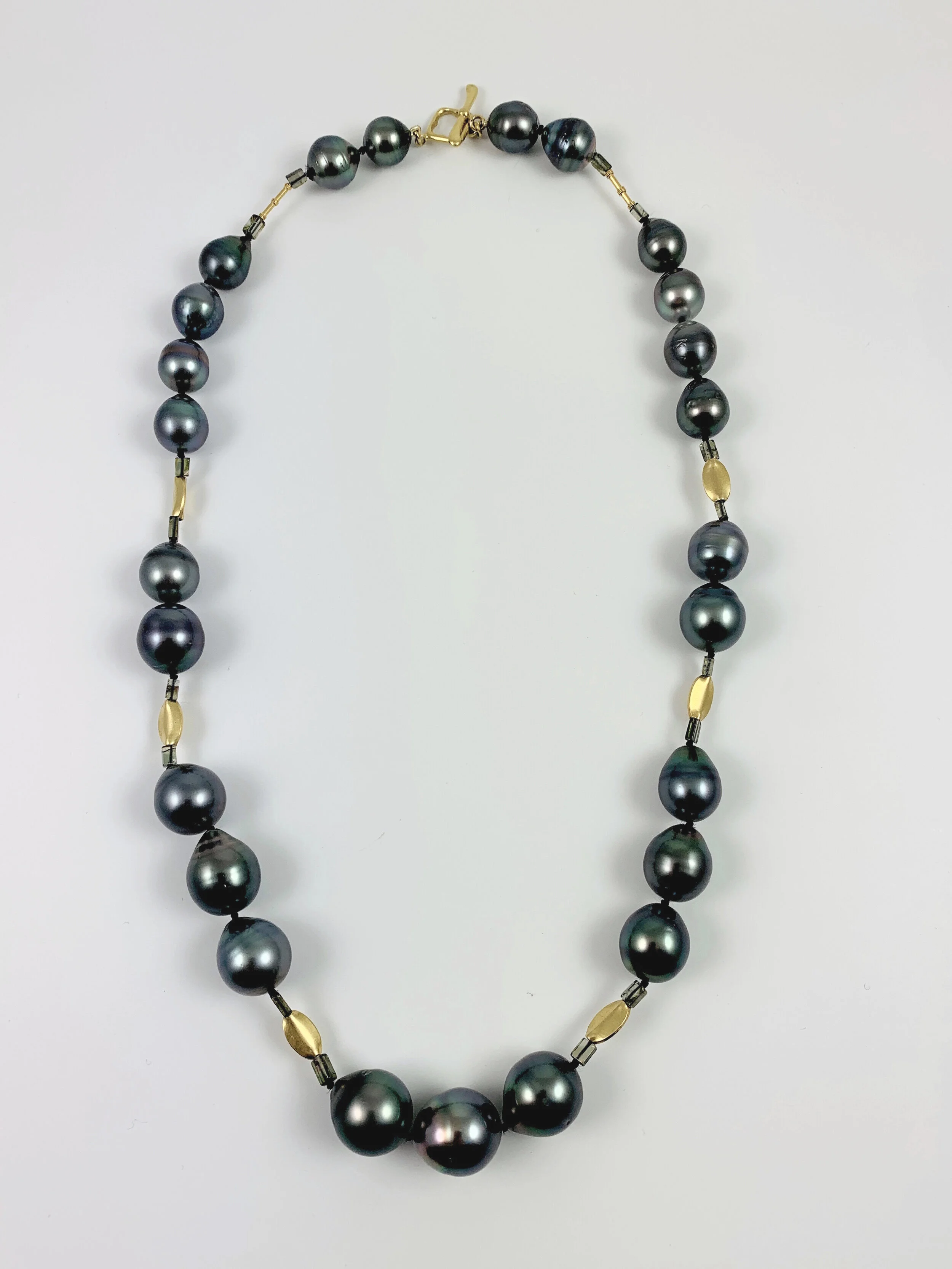 This 21 inch Tahitian Peacock Pearl necklace is accented with 22K beads and toggle.  Geometric  tourmaline beads add sparkle.