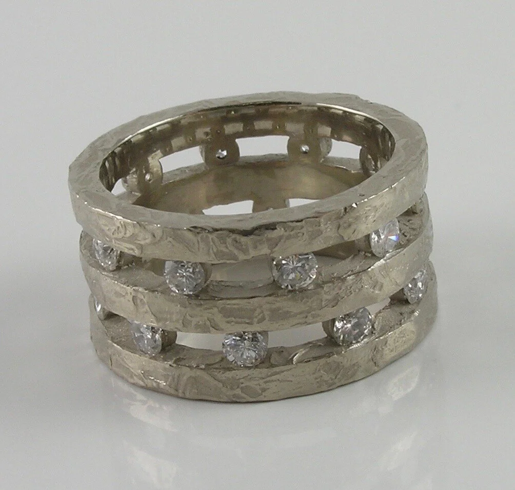 For Taya. The triple stack band holds her stones in open channels. 18KPW
