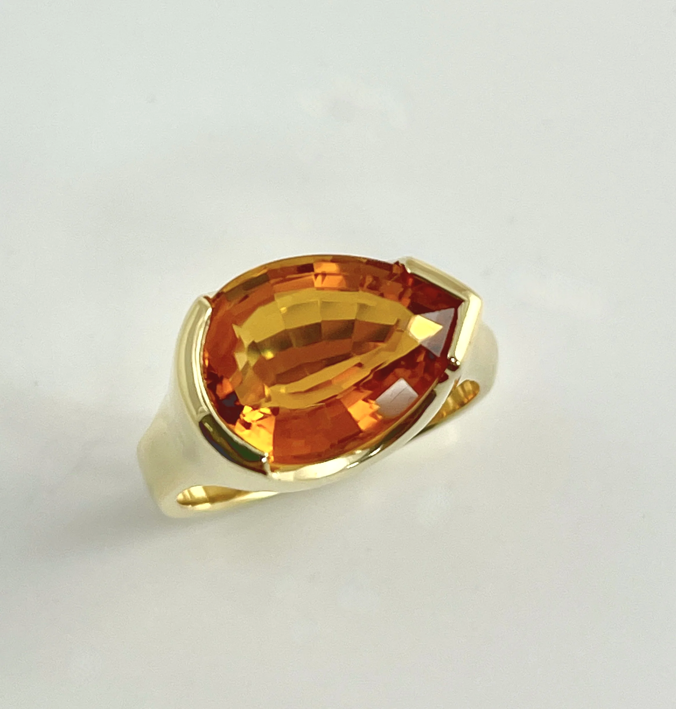 For Thea. A 5.58ct pear shaped citrine, set horizontally in a partial bezel. 18K.