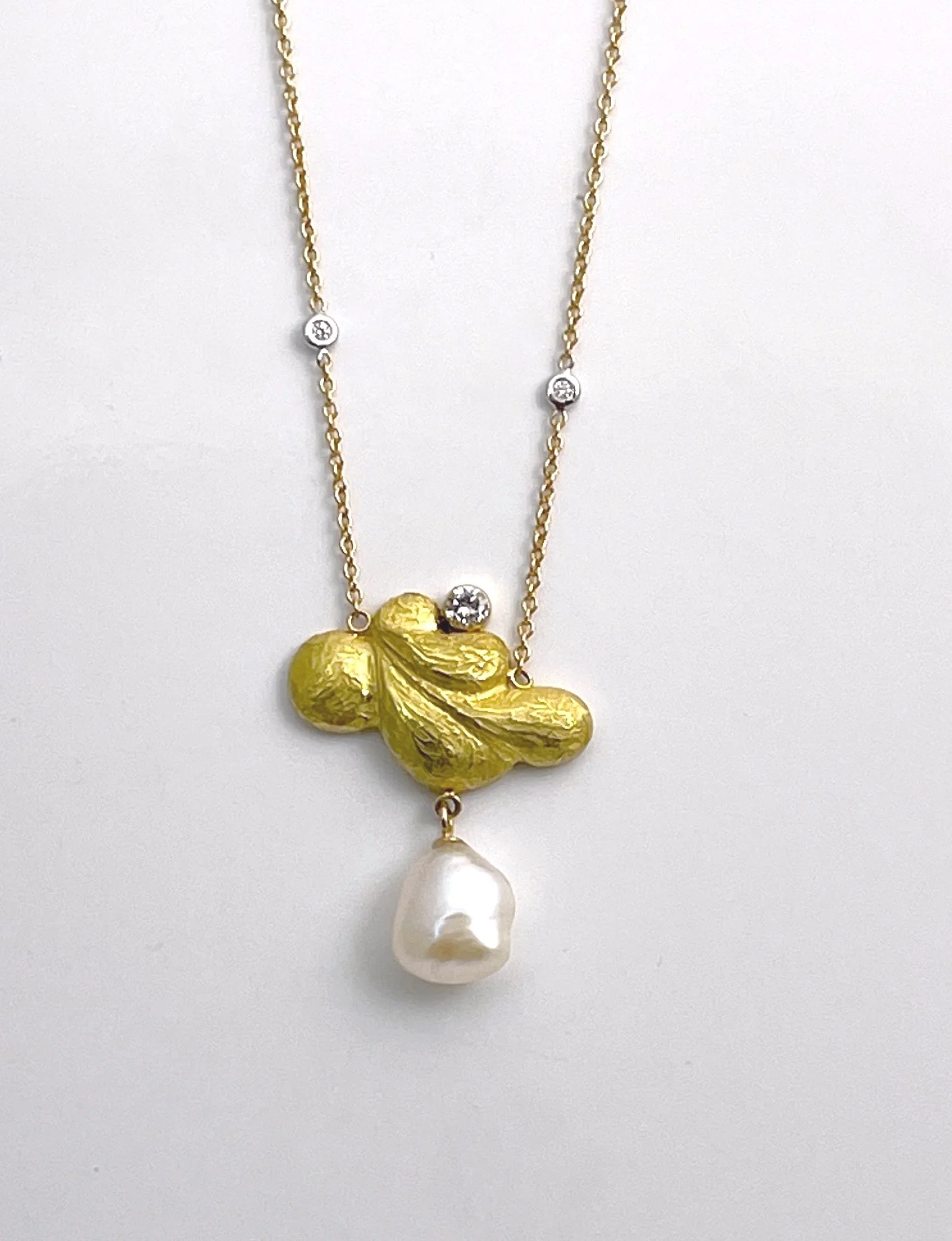 “Let the mind rest on a cloud.”  This necklace was inspired by a quote from a Tai Chi Master.  The diamond rests on an 18K cloud.  The Biwa pearl billows below.  The 18K chain is dotted with diamonds. 