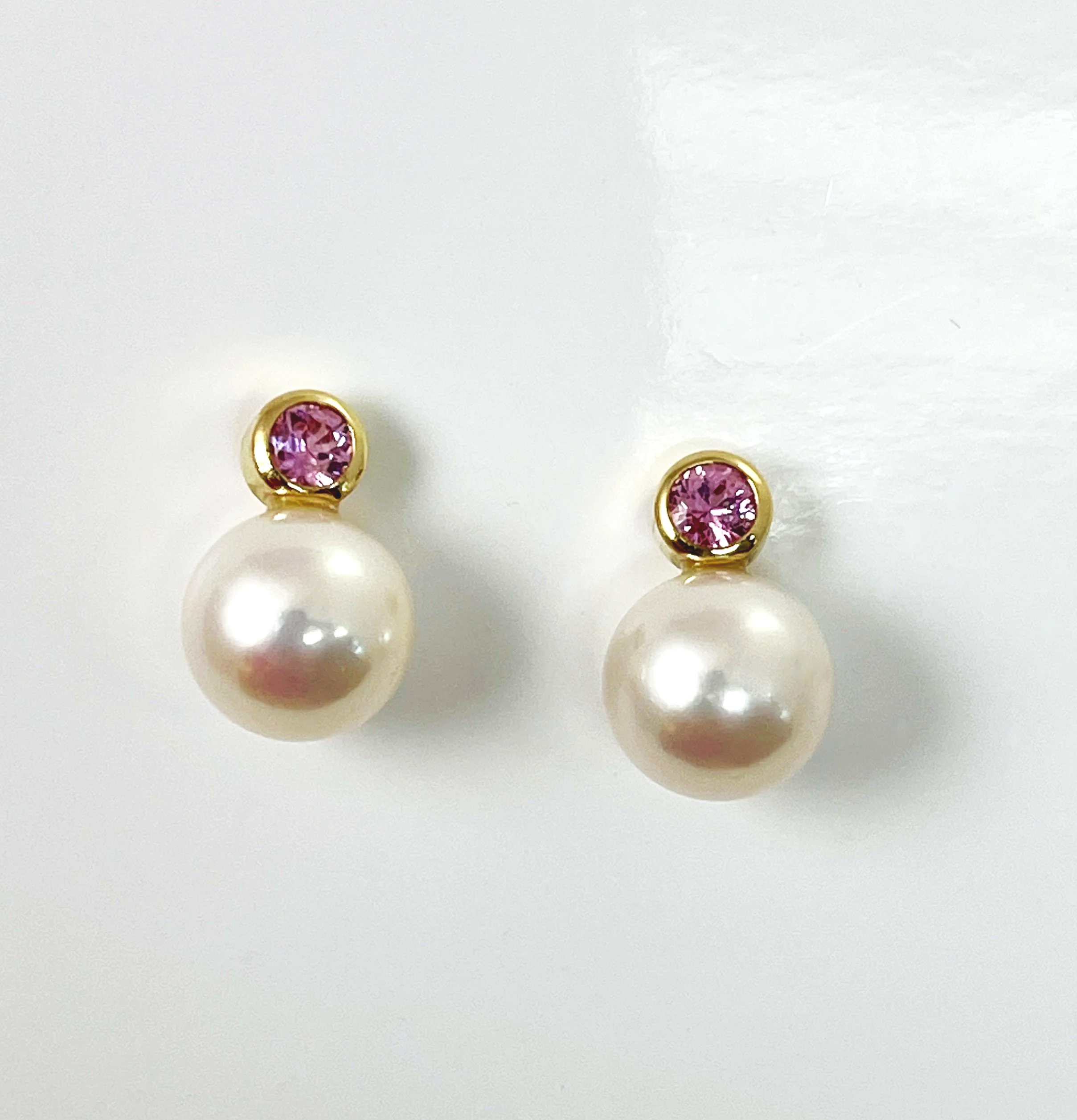 Innocense:  Pink sapphires set in 18K bezels accent the satin like  Chinese fresh water pearls. 