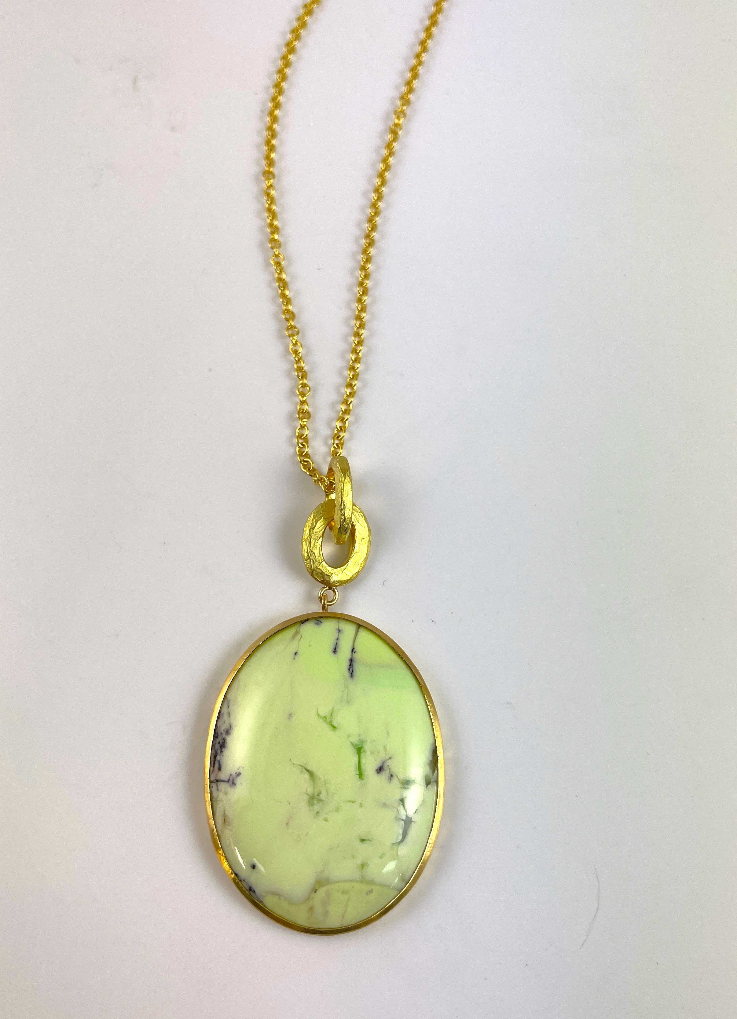 For Wendy. Her chrysoprase cabochon was set in 18K. The bezel and rings have a "windswept" texture.