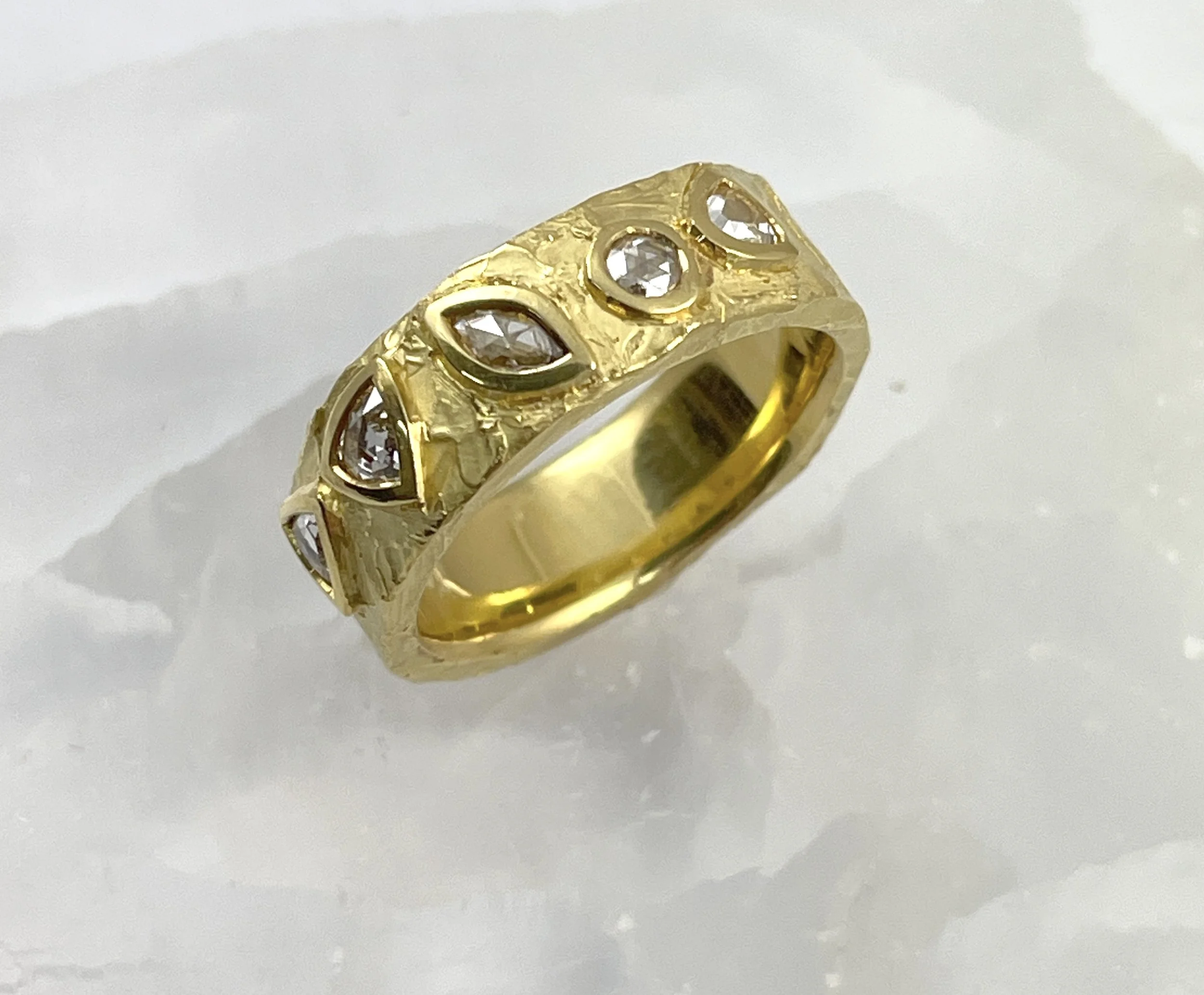 18K band set with rose cut diamonds, totaling 0.56ct.