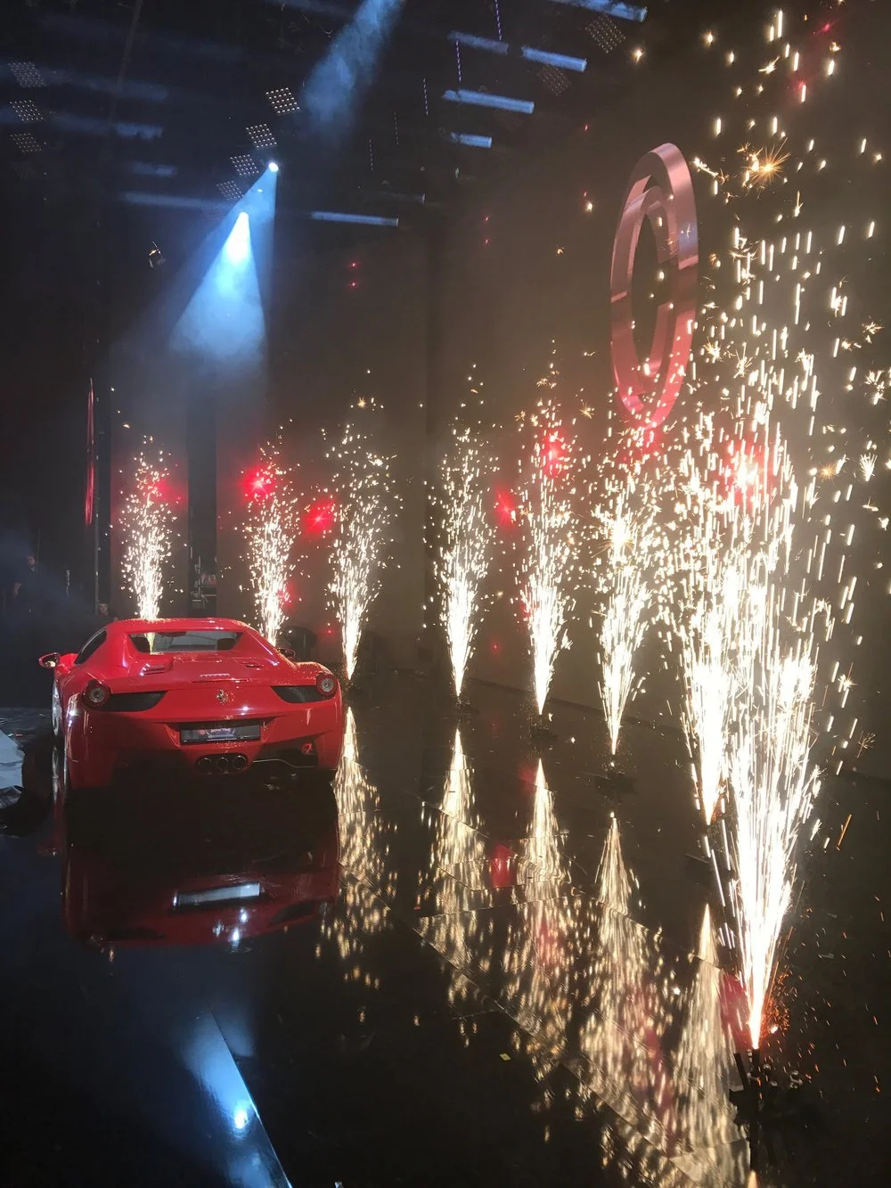 Stage illusion with a car appearing amid pyrotechnics - magic act development and show consulting