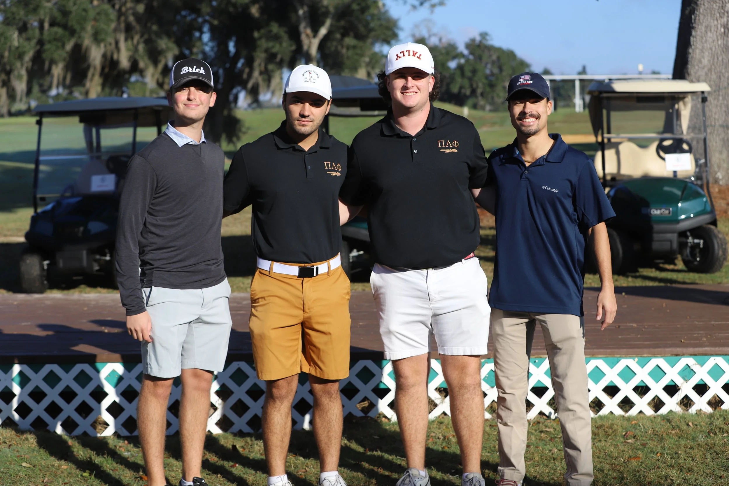 IFC Members posing and smiling on a golf cart during the Annual IFC Charity Golf Invitational.