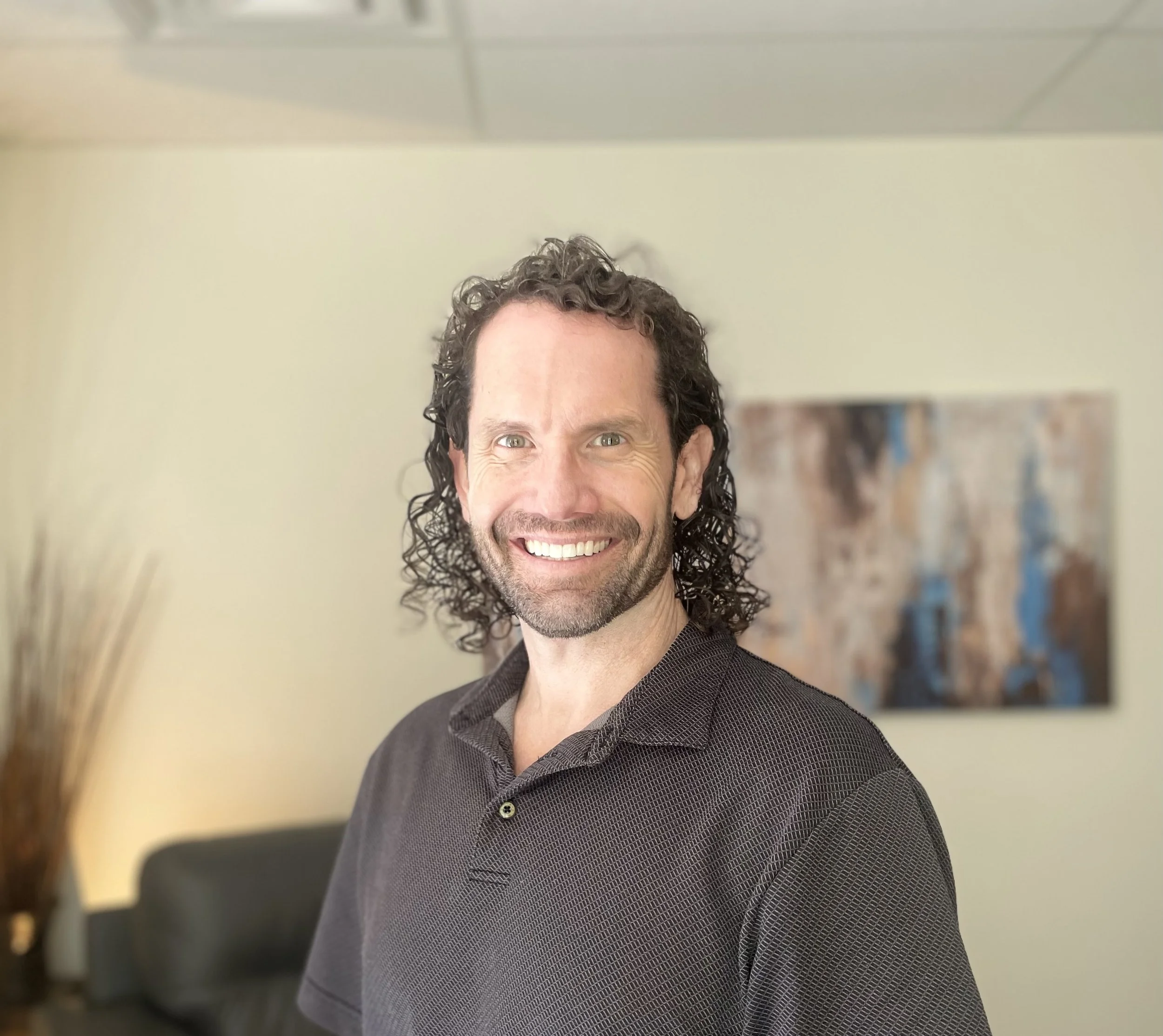 Jon Portillo, LPC, standing in his therapy office at First Day Counseling in Broomfield, Colorado