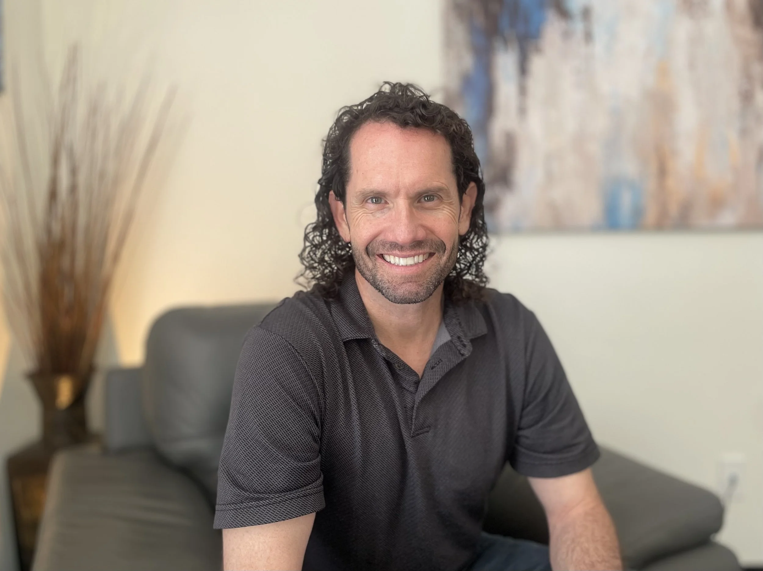 Jon Portillo, LPC, seated in his therapy office at First Day Counseling in Broomfield, Colorado