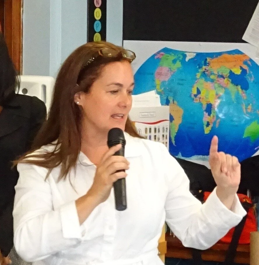 Patricia speaking before a classroom of future global citizens in the classroom.