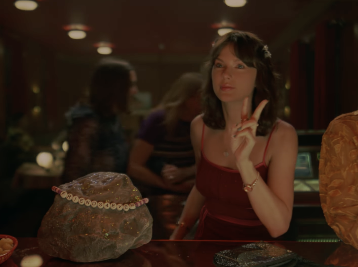 Taylor Swift Opalite music video with jukebox in the background