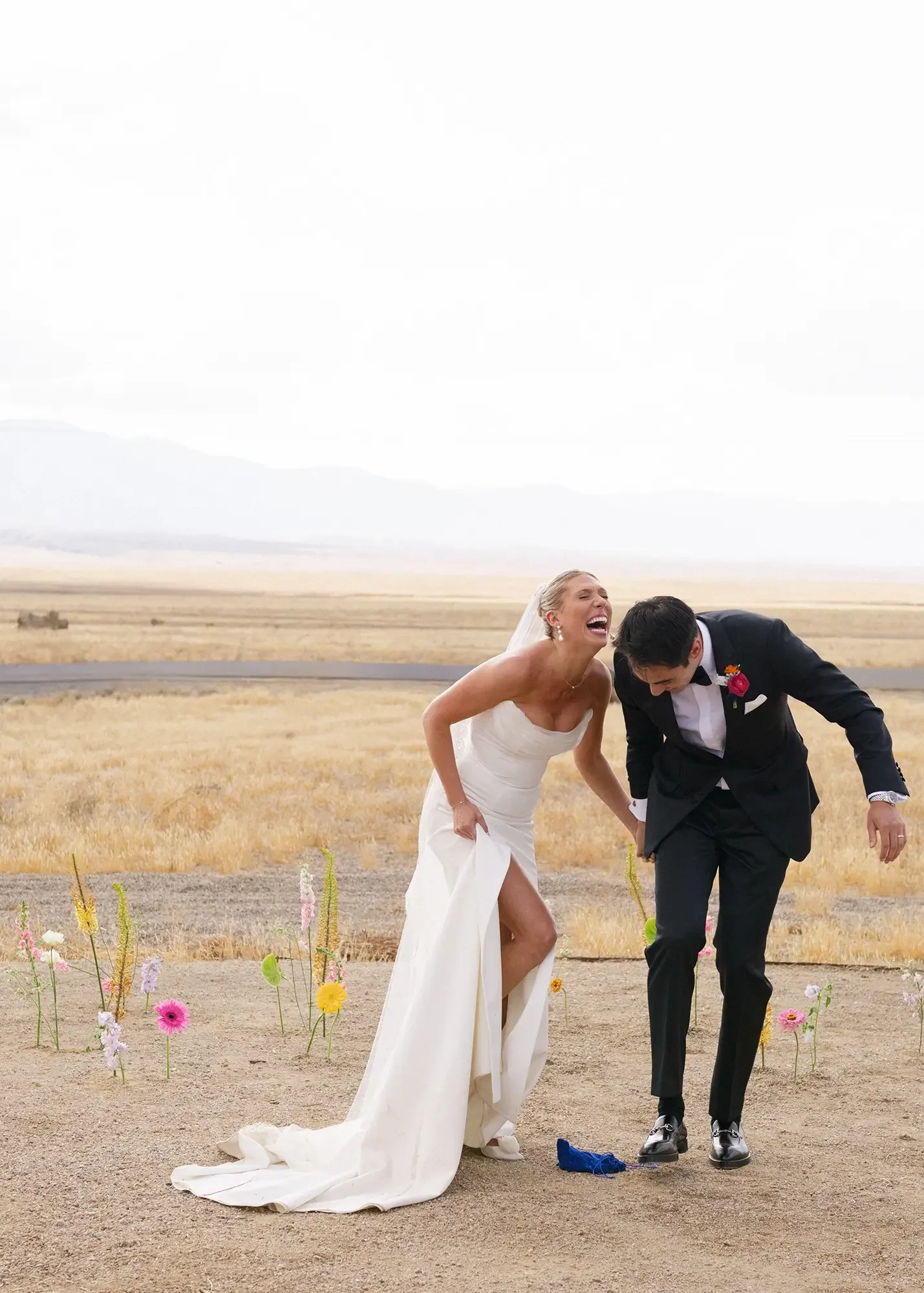 A bride and groom laughing after they smashed the glass during their ceremony. 