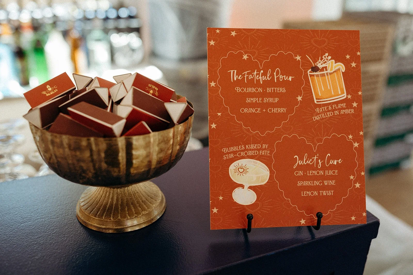A bowl filled with small rectangular boxes and an orange-themed menu card on a dark surface.