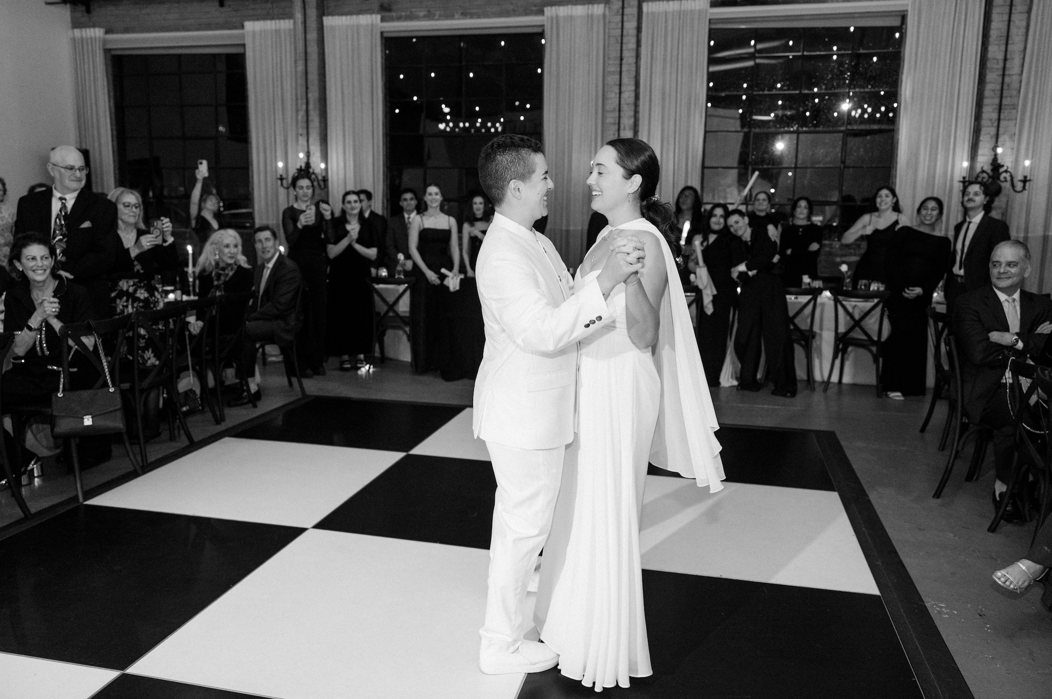a black and white photo of a same sex couple dancing on a black and white dance floor at Soho South