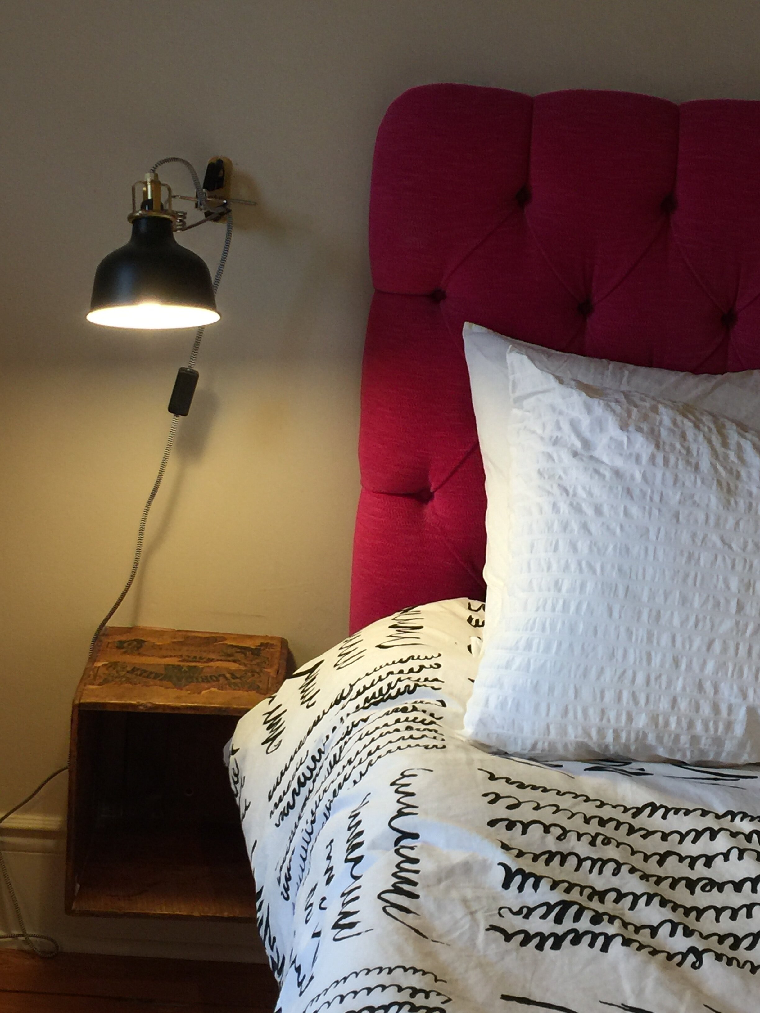  My favourite IKEA wall light, Ranarp, and an old butter crate as a bed side table.  