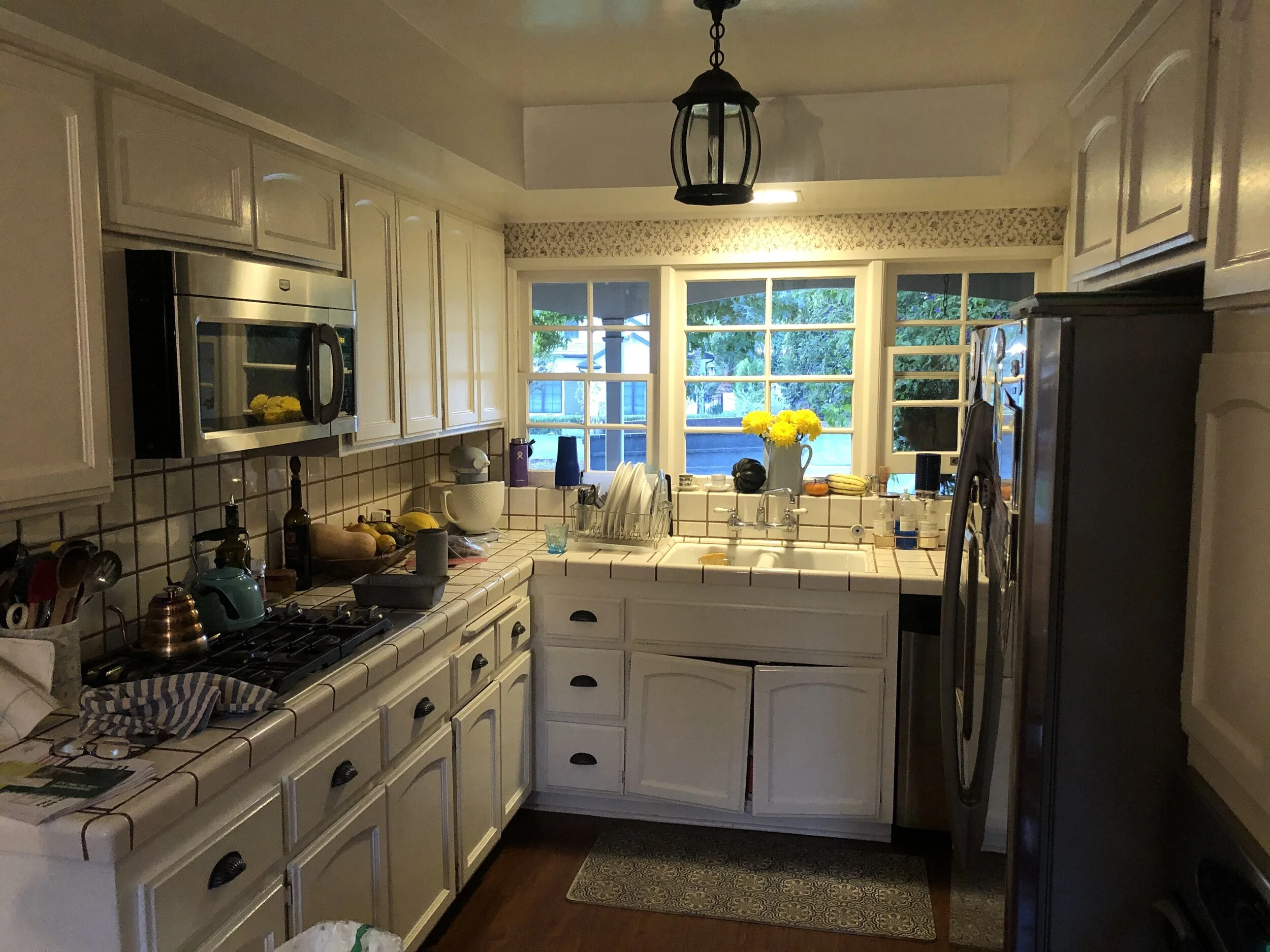 Before: Main sink area, south wall (also please notice how the cabinet doors are barely hanging on)