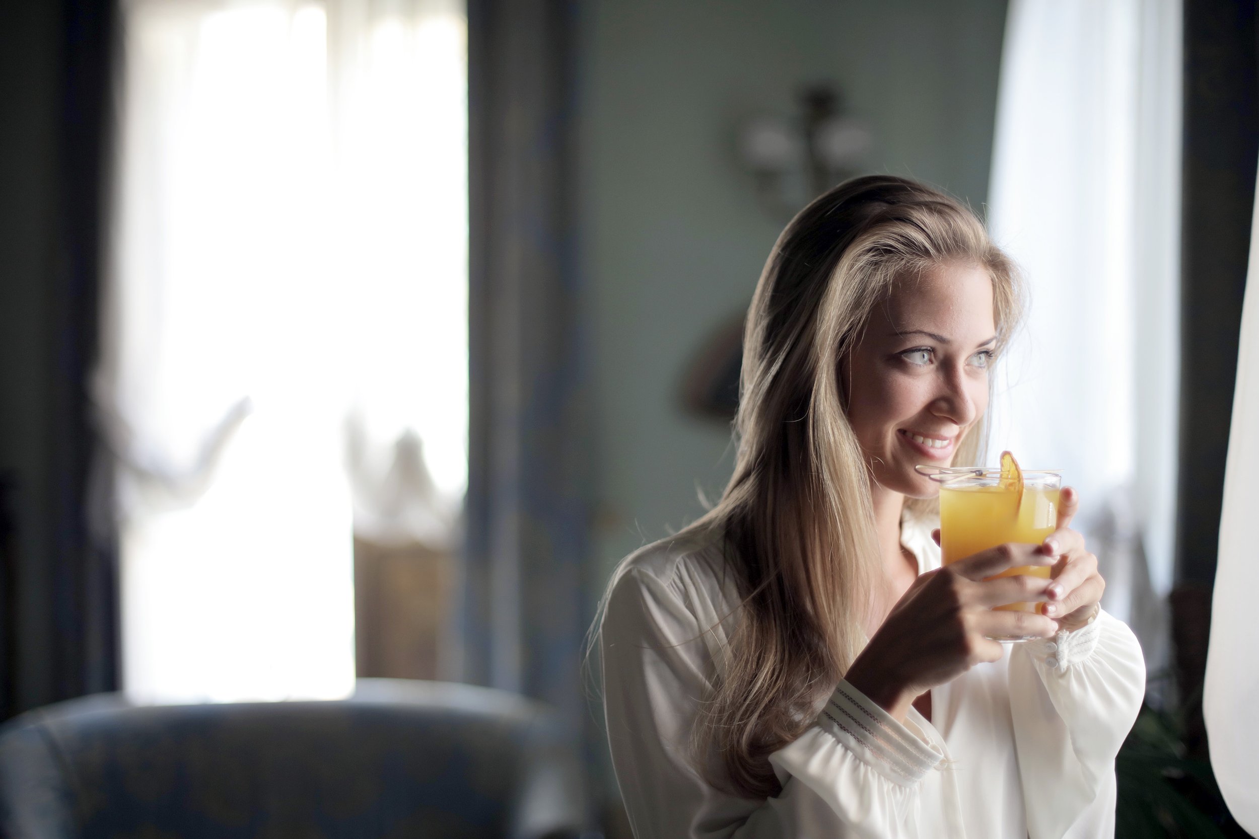 woman enjoying a mocktail at home
