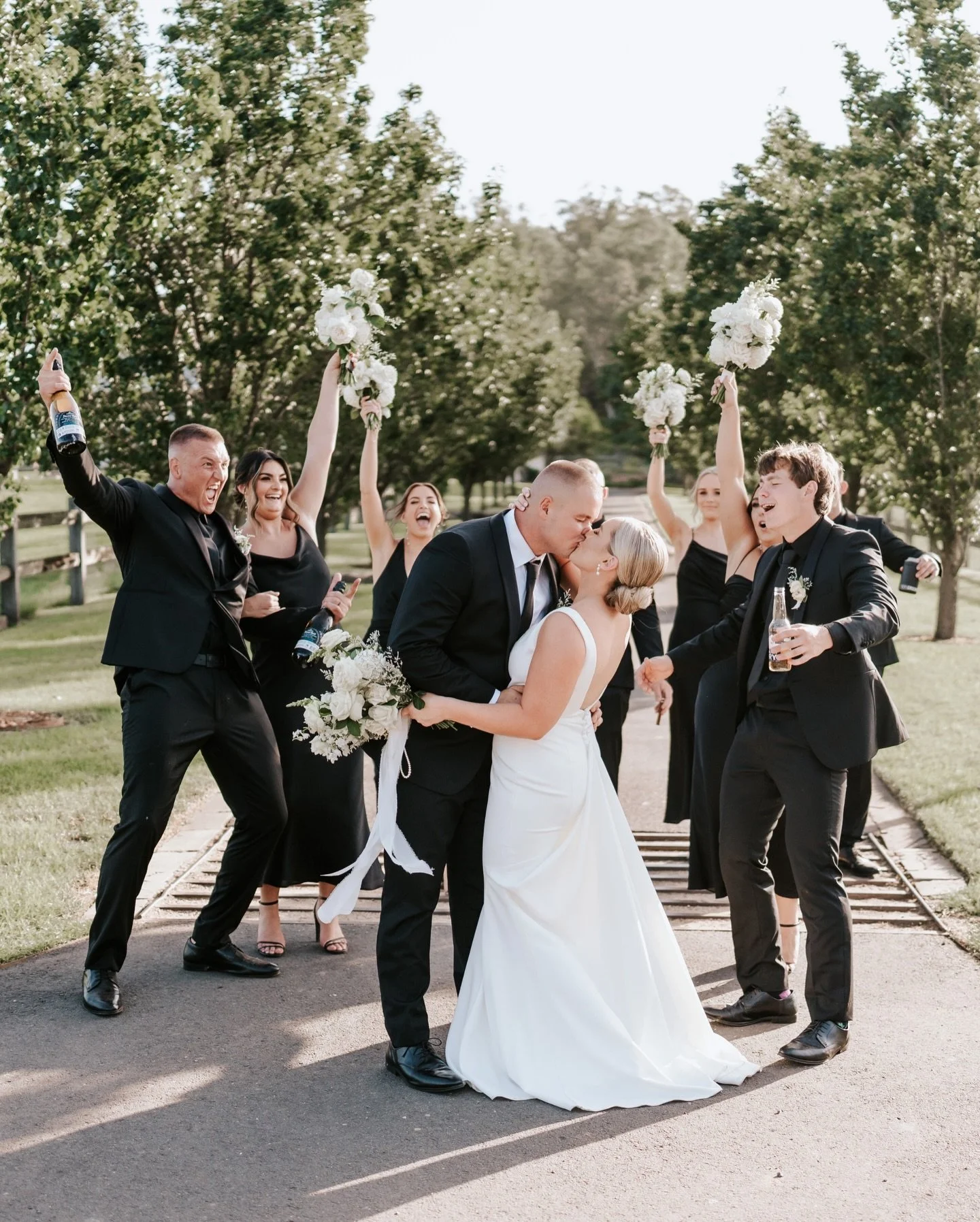 Caprice &amp; Cooper loved up, surrounded by their numbers 1&rsquo;s. The ornamental pear driveway makes for an impactful backdrop