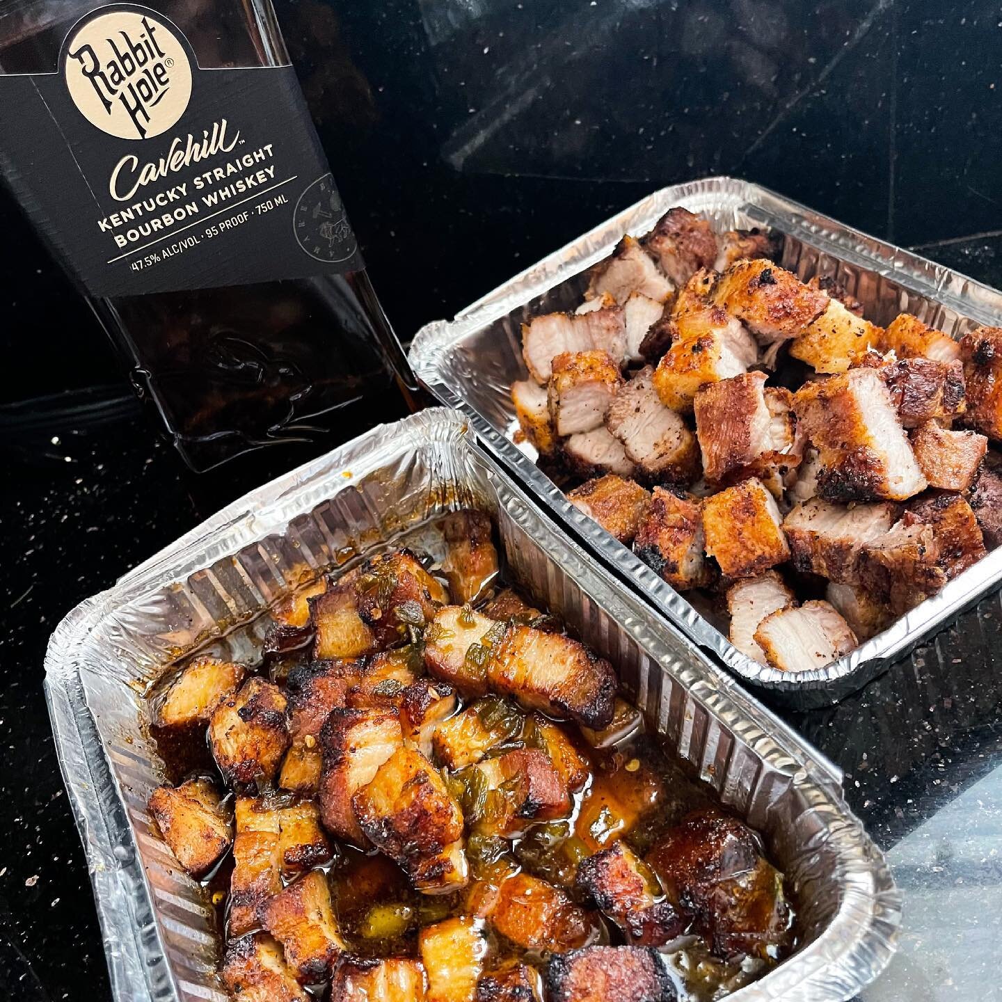 Pork Belly along with a bottle of @rabbithole Cavehill Bourbon Whiskey. 
Watch that initial maple bourbon with chilies glaze being poured over crispy pork belly before I place it in the grill again for its final charred up glaze. 

This is how we cel