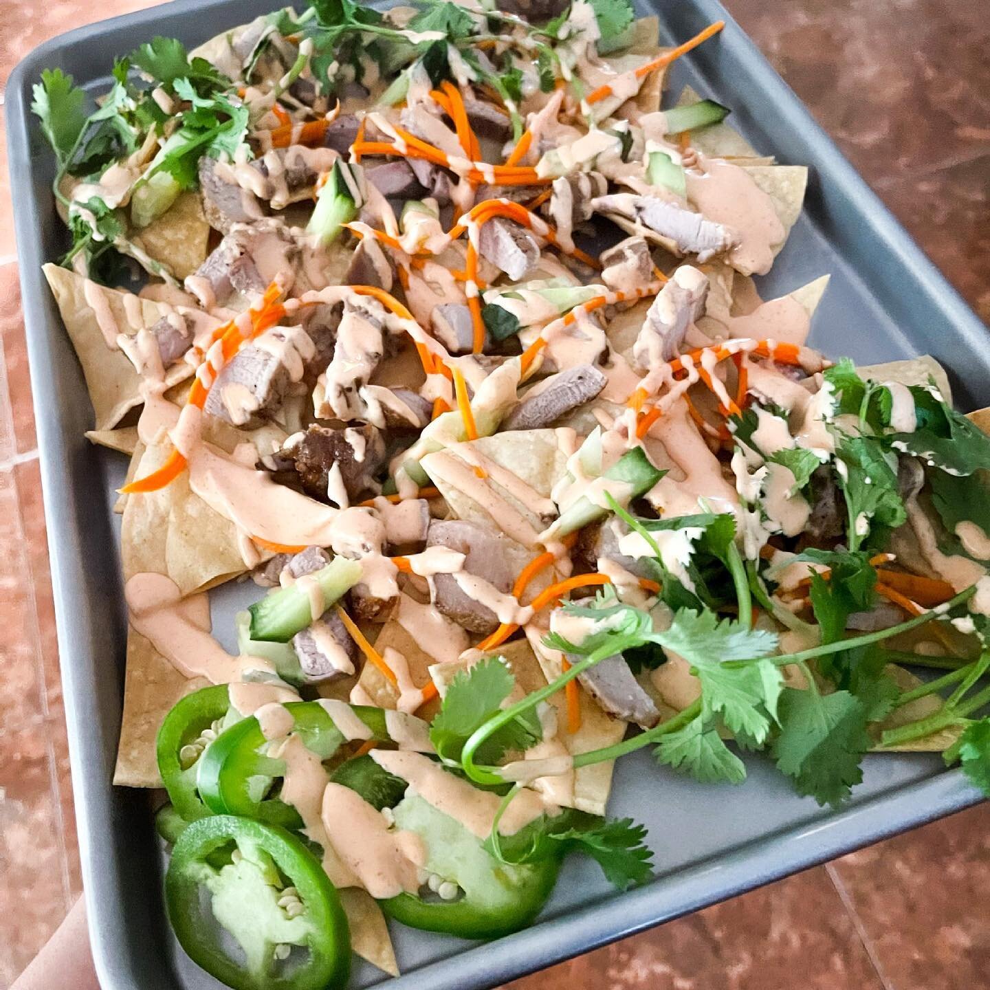 BANH MI NACHOS
I was craving banh mi and craving some chips so let&rsquo;s combine em together! 
I grilled up the pork using the easy marinade recipe found in my cookbook for banh mi and added all the fixings: 
&bull;sliced cucumbers 
&bull;carrots /