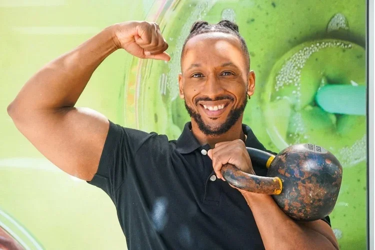 Coach Chris, certified personal trainer, holding a kettlebell