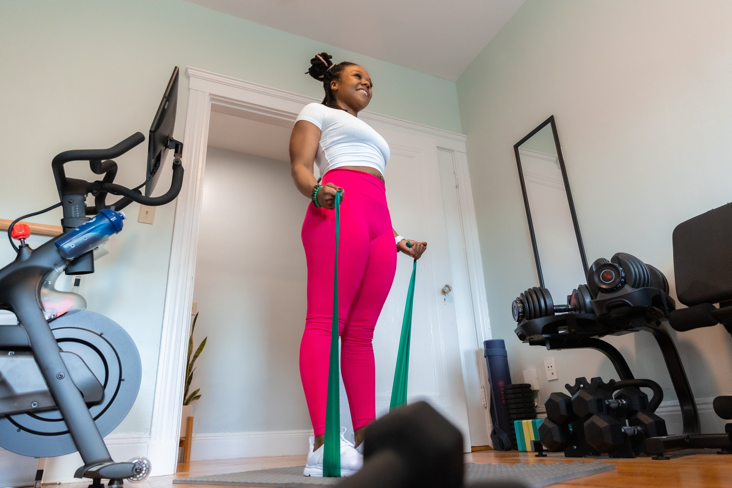 Daneita performing a resistance band workout during in-home personal training