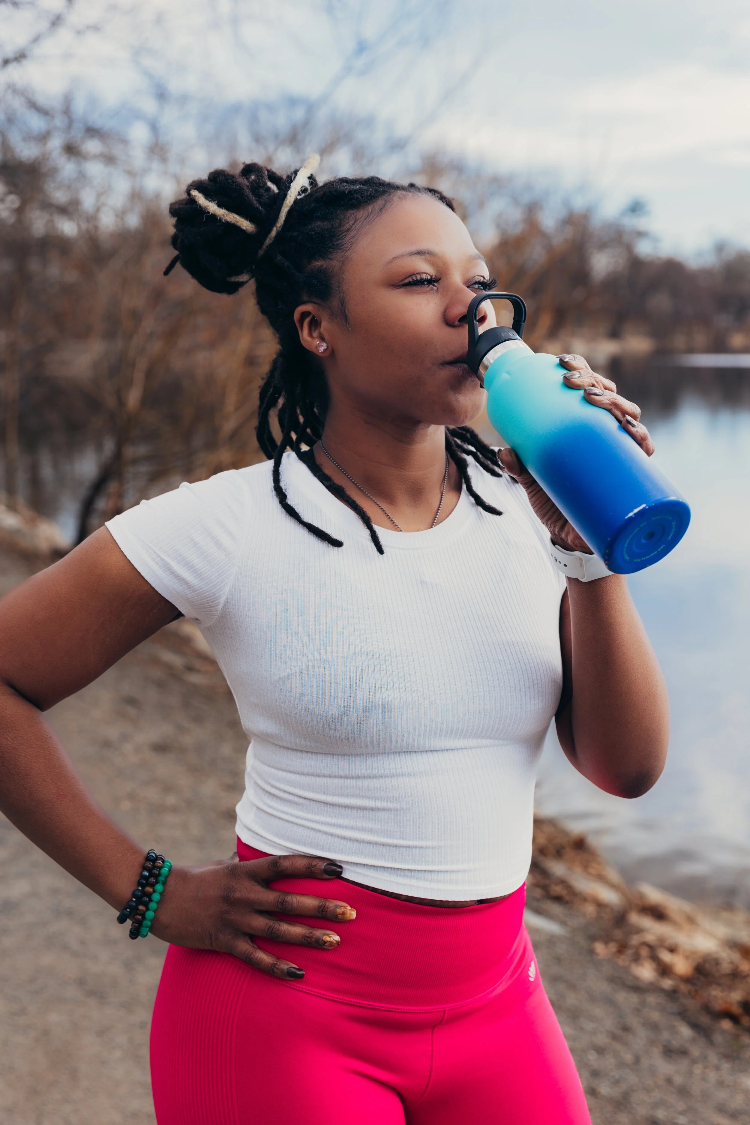Client hydrating outdoors after a fitness and stretch therapy session