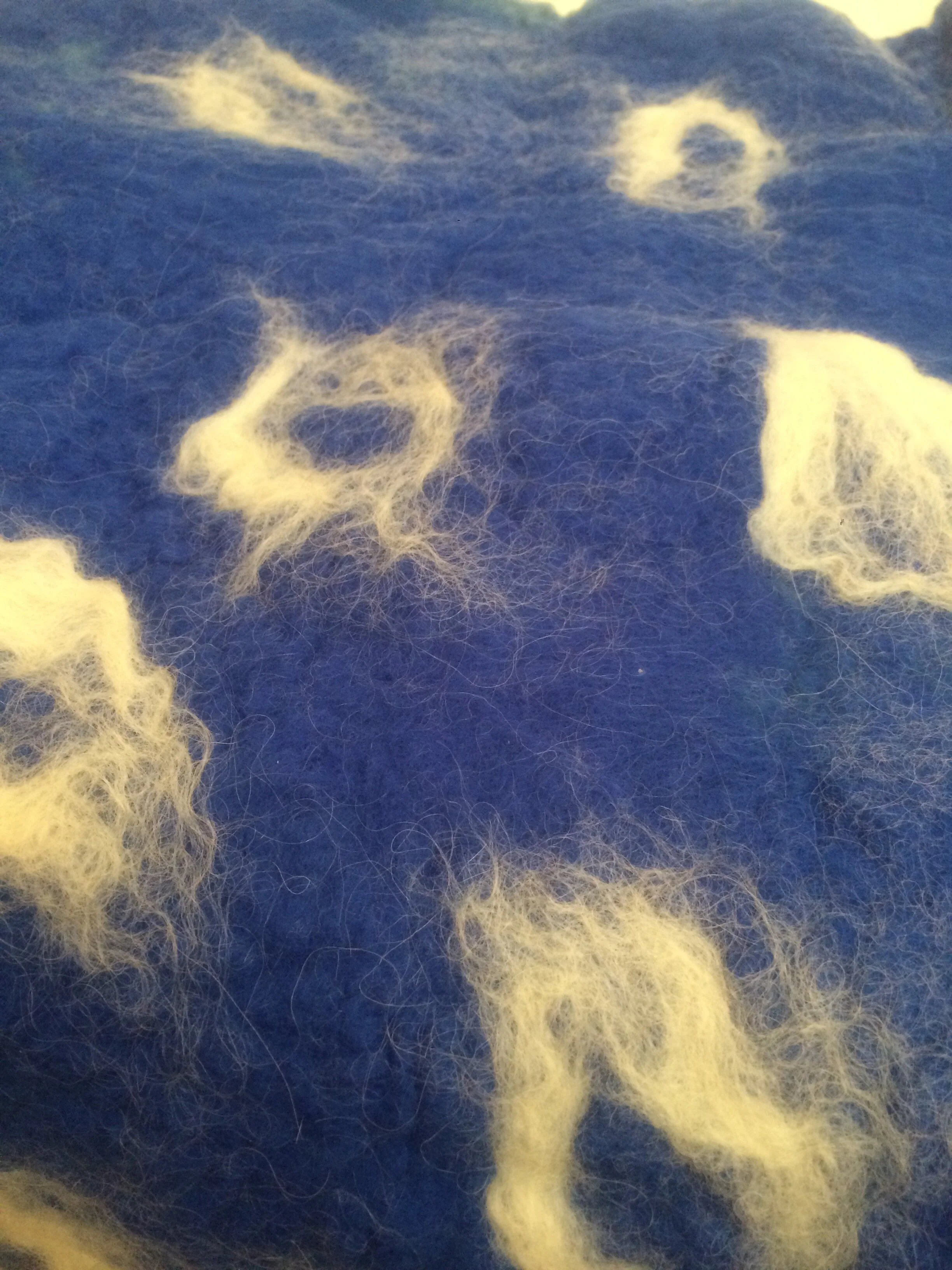 lambs wool made into felt and silk circles 